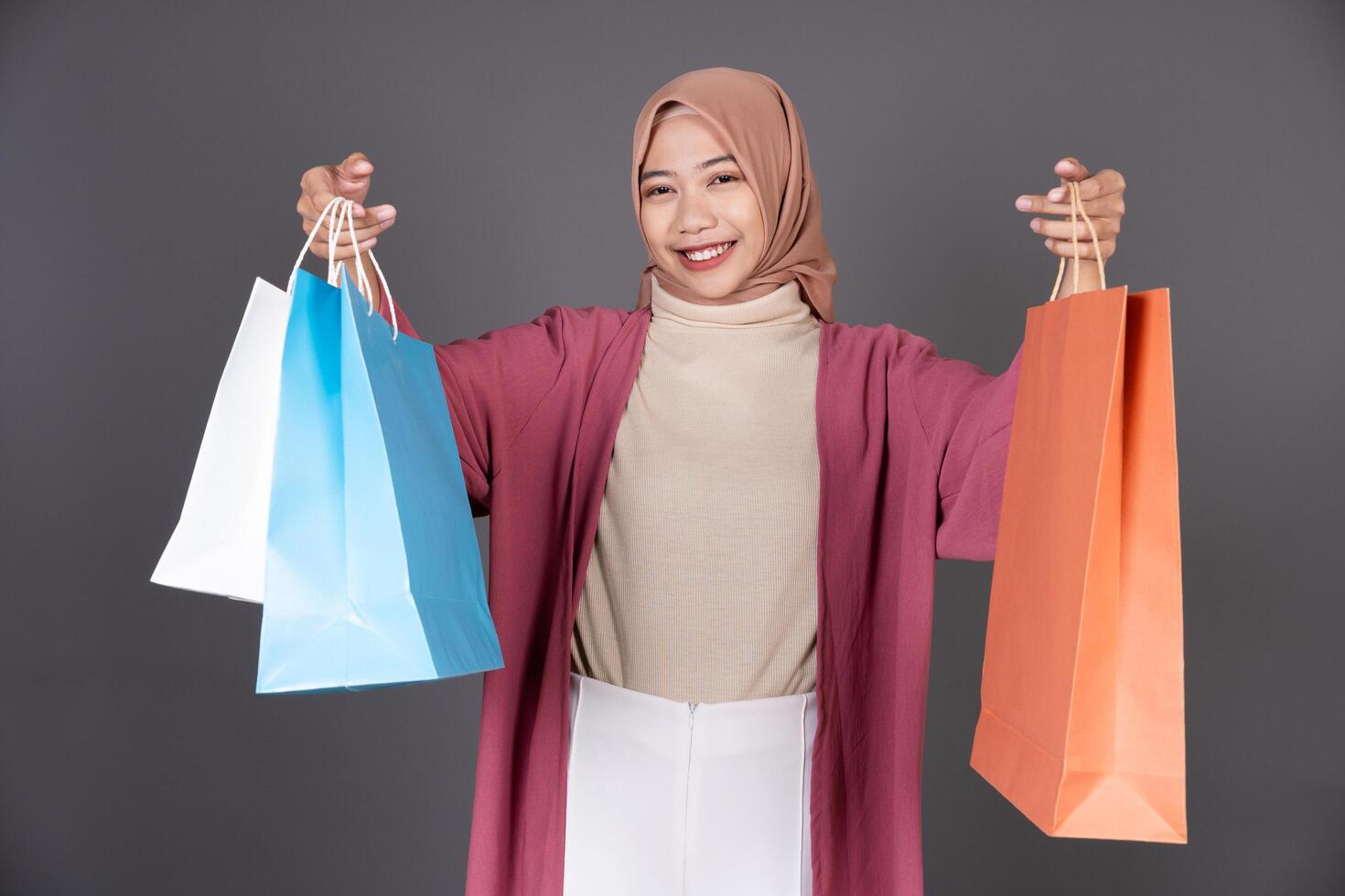 Hijab Female Carrying a Shopping Bag Isolated Background photo