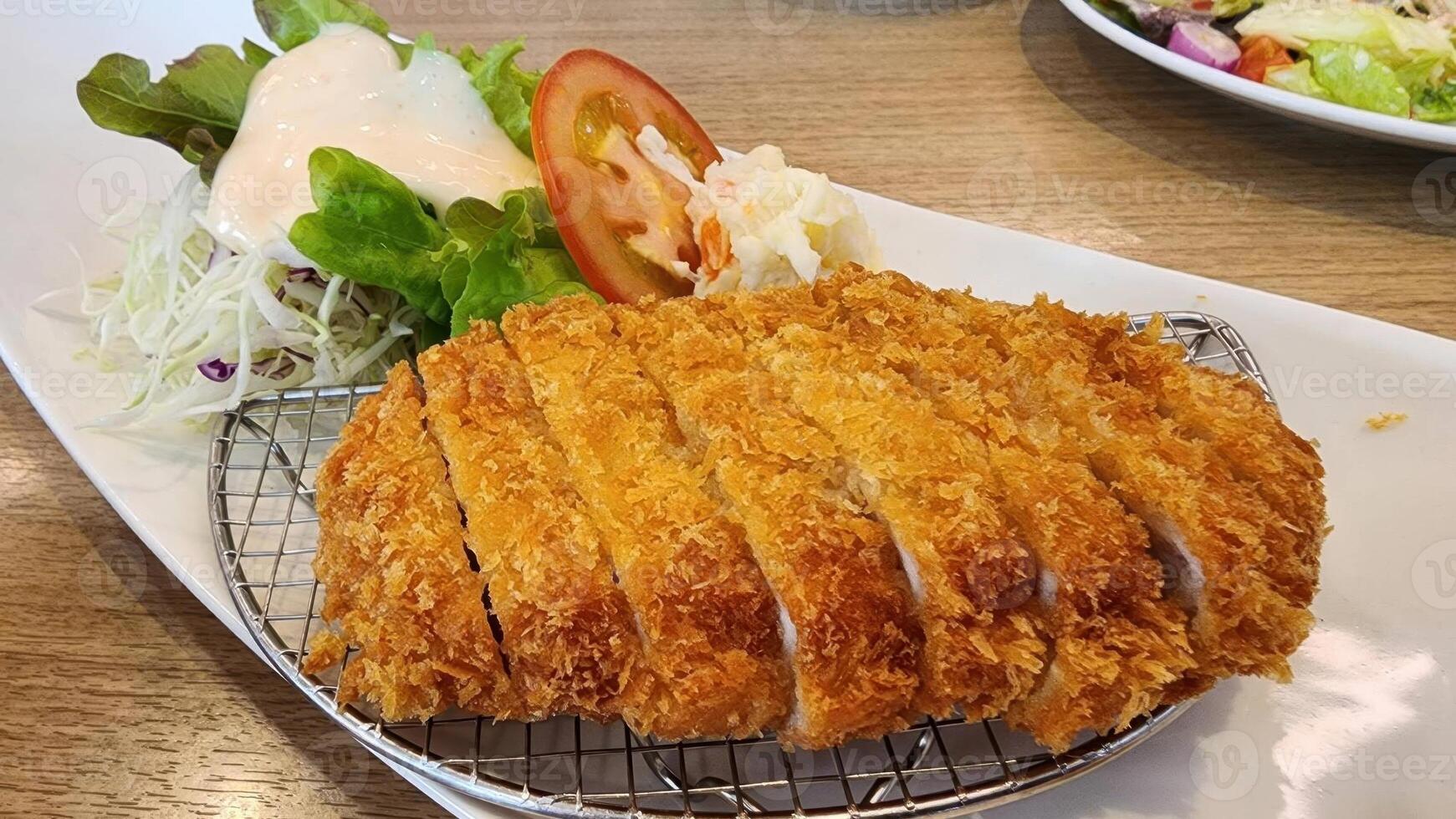Crispy Breaded Chicken Cutlet with Fresh Salad and Tomato Slice photo