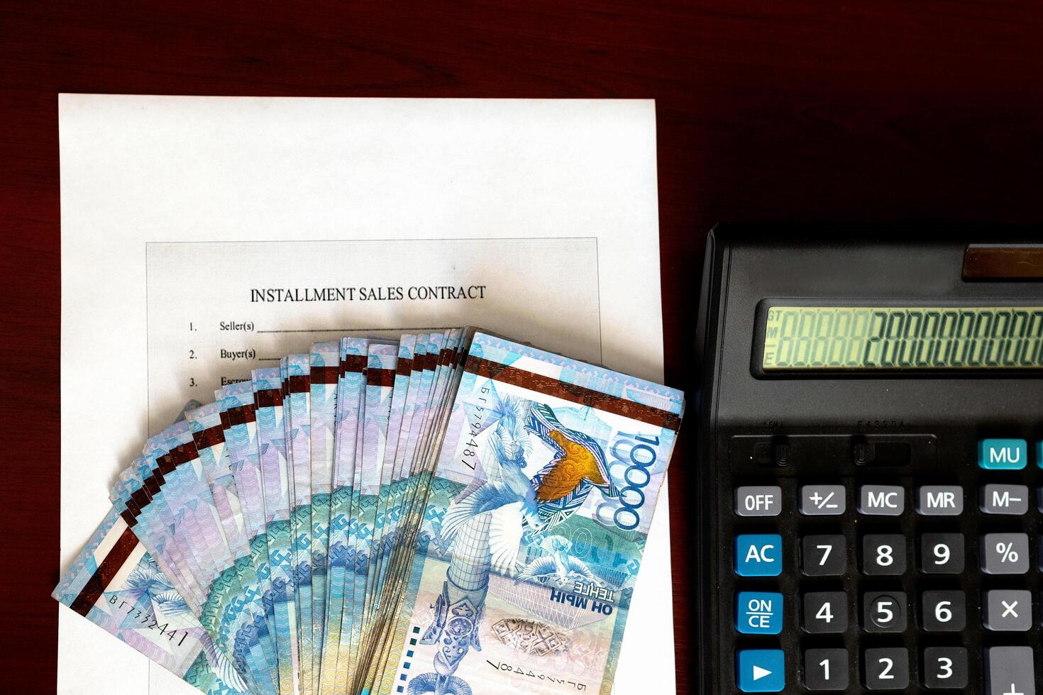 Paper Kazakh money and calculator on the table close-up. photo