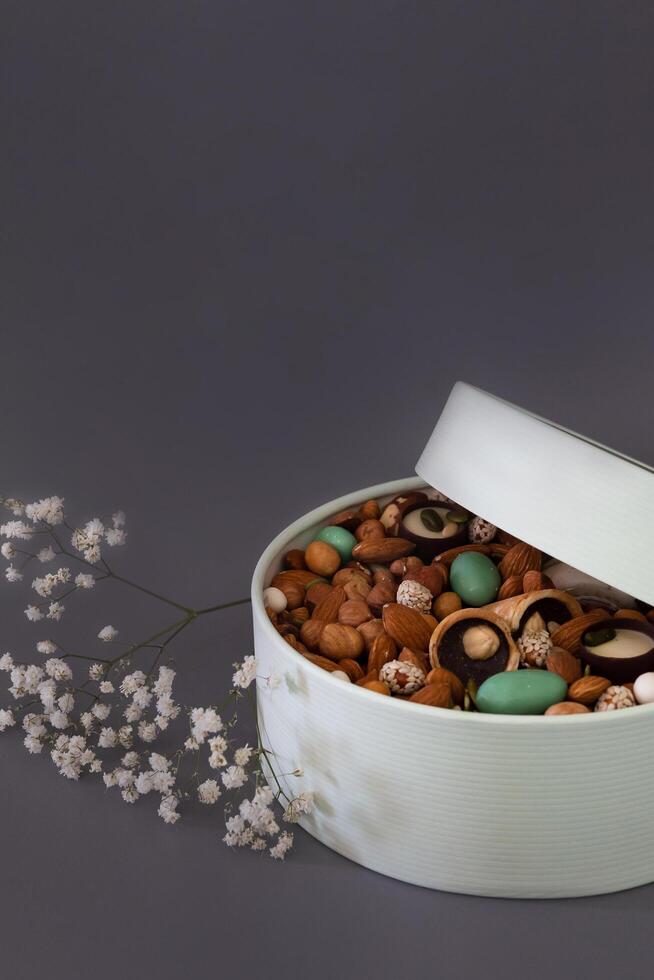 Peanuts in box. Gift to Women's Day Mother's Day Valentines day. Festive round box. photo