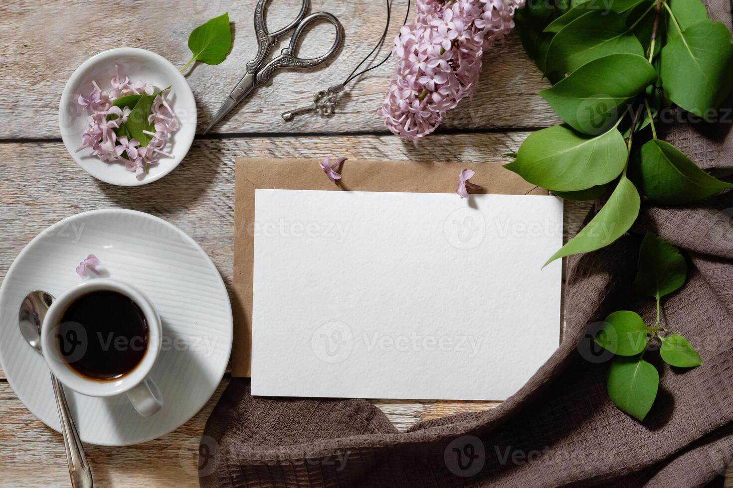 Greeting or invitation card mockup with gift box, envelope and spring lilac flowers photo