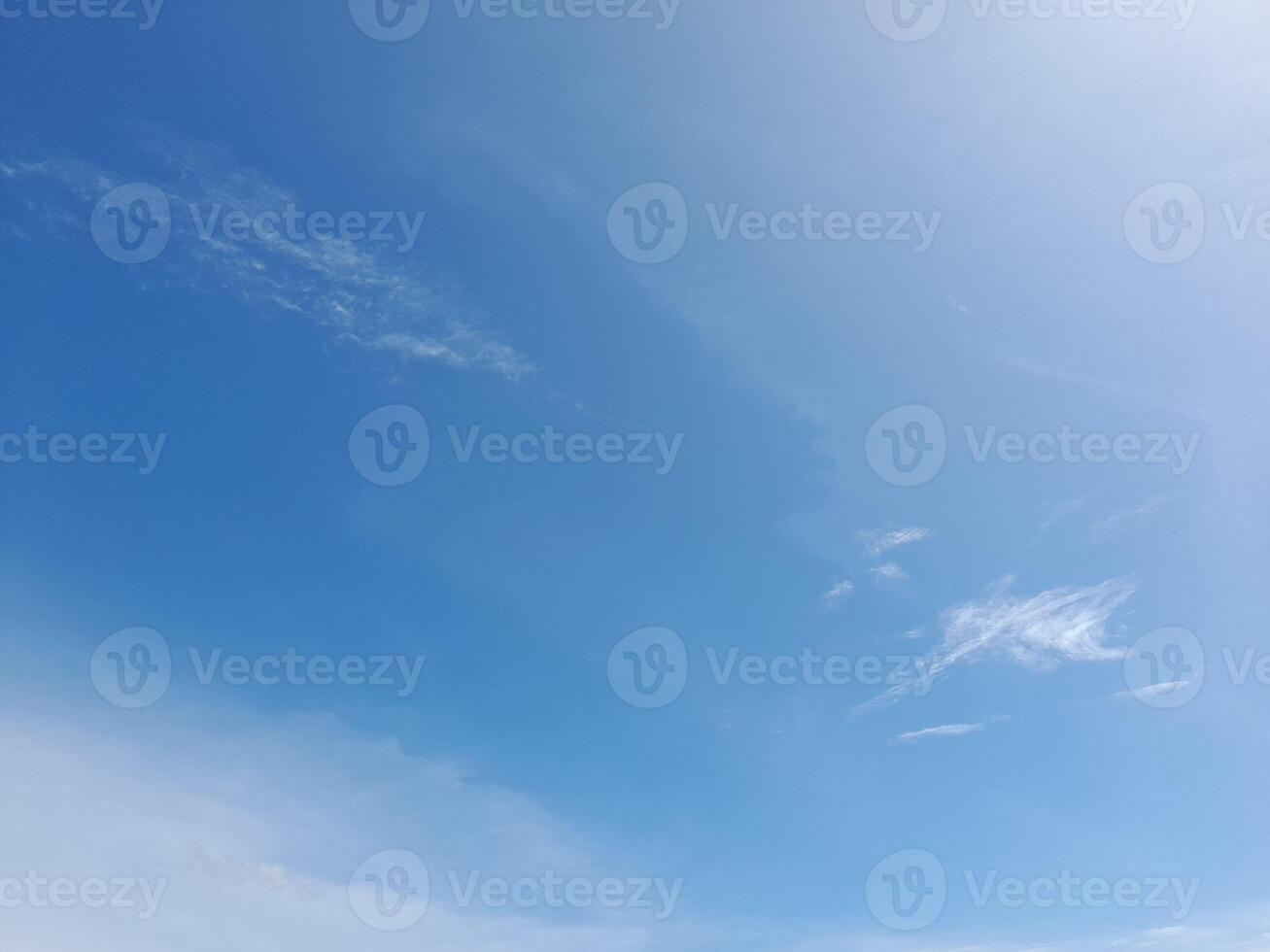 White clouds in the blue sky. Light cloudy, good weather. Curly clouds on a sunny day. photo