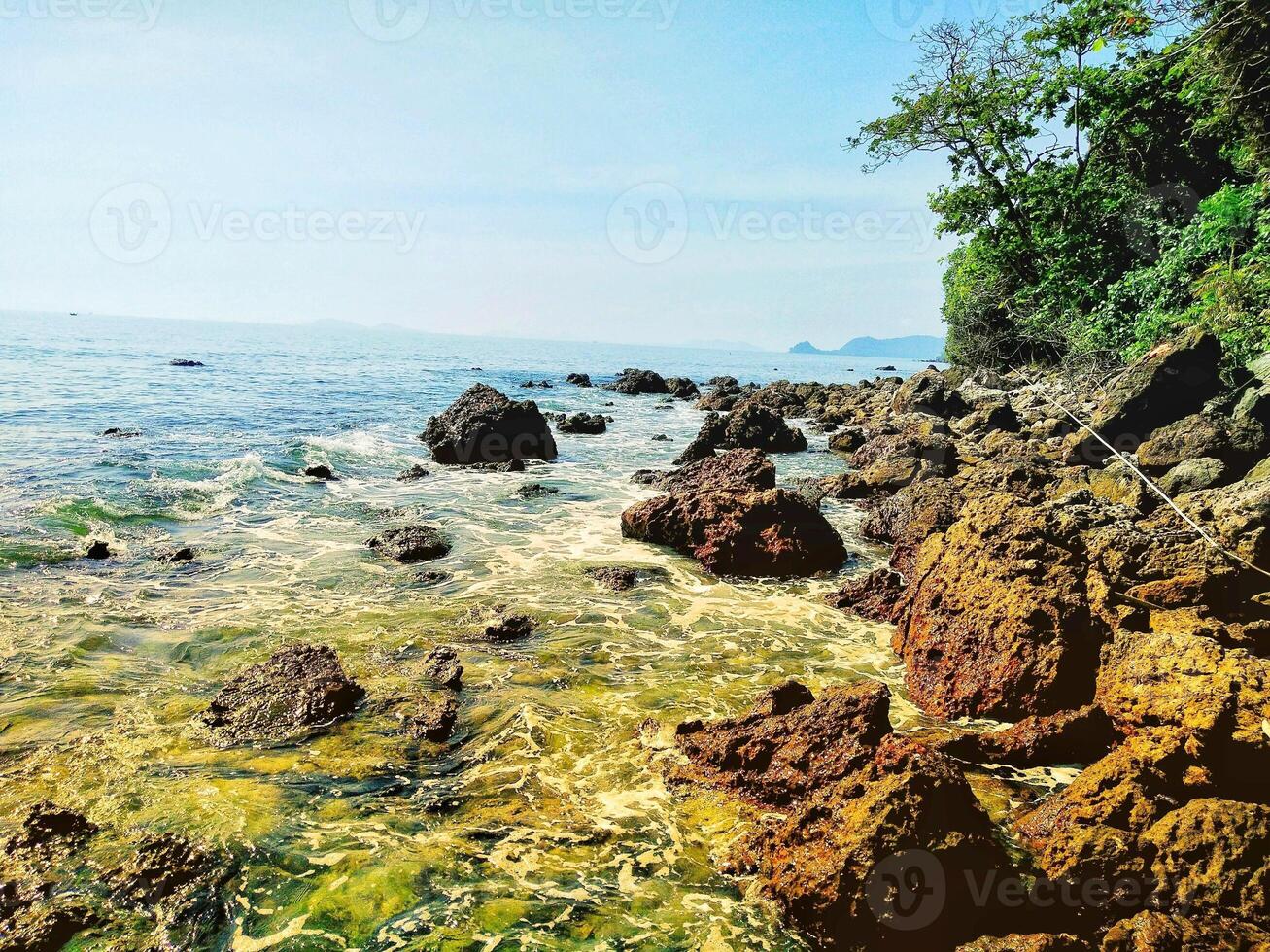 Beautiful rows of brown rocks and the blue sea in Chumphon photo