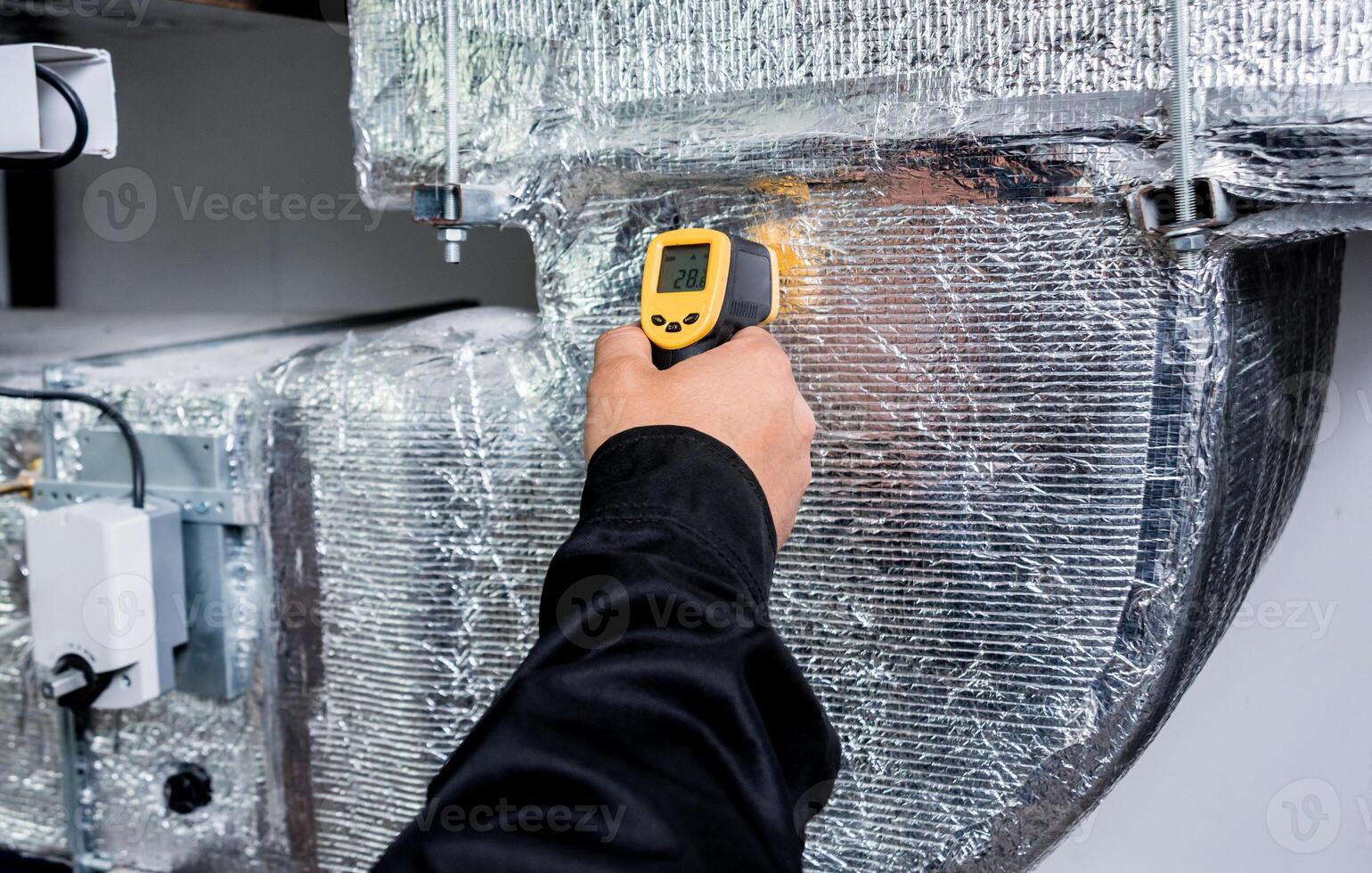 Technician use infrared thermal imaging camera to check temperature at fuse-box photo