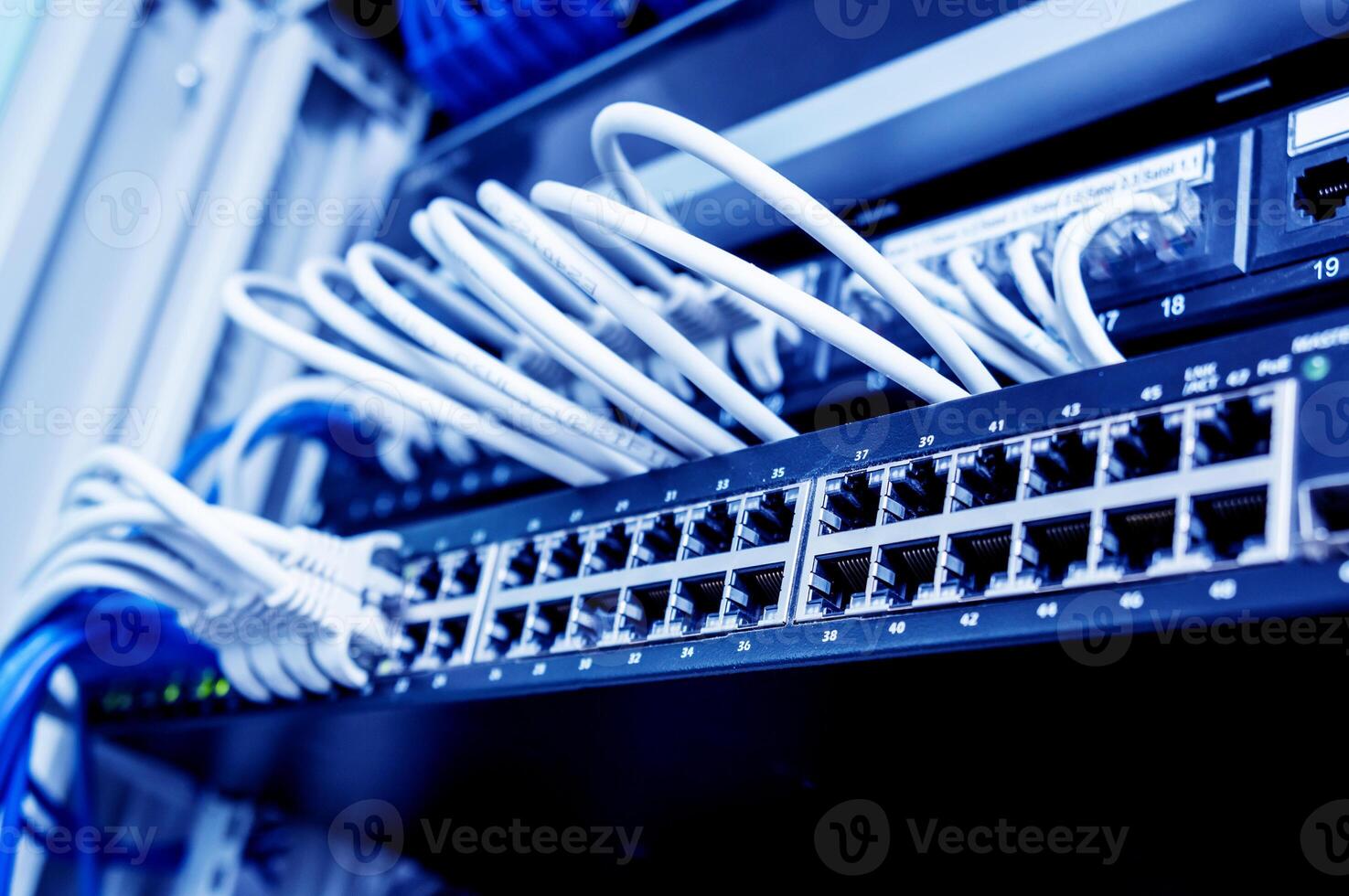 Network switch and ethernet cables in red and white colors. Data Center photo