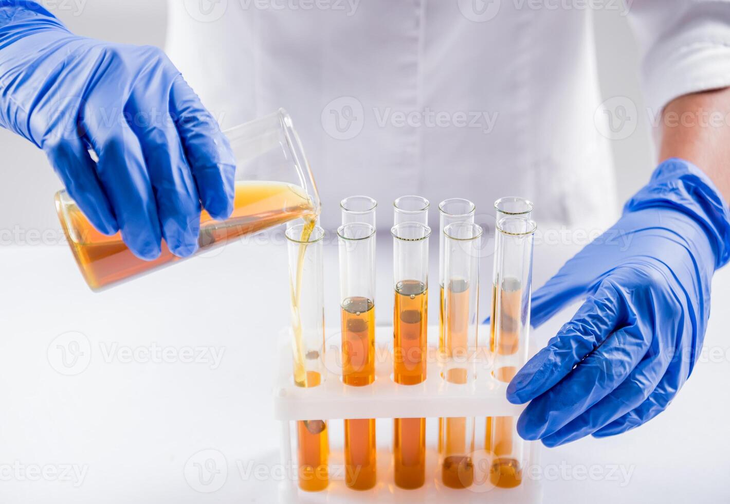 Scientist pouring organic oil. Beauty and cosmetics sciences. photo