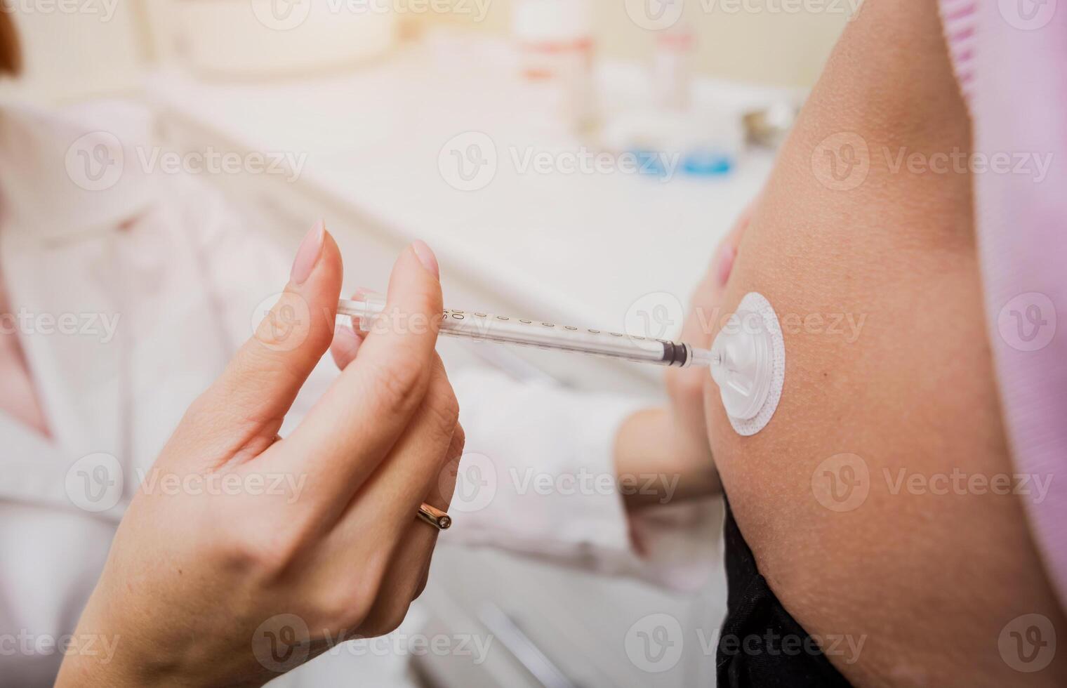 Doctor makes an injection of insulin with a catheter. Doctor injects insulin photo