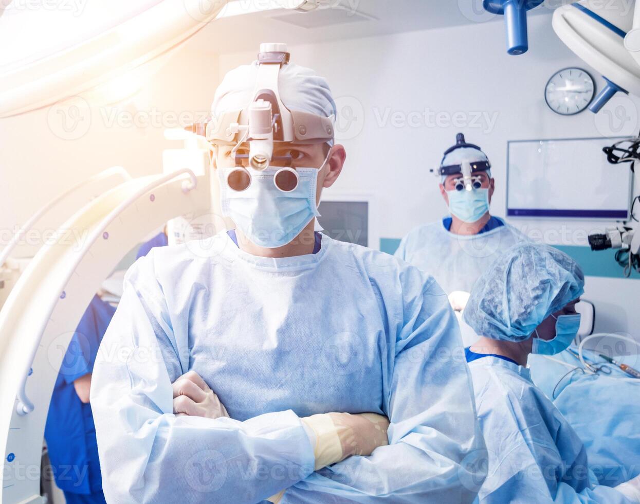 Portrait of spinal surgeon in operating room with surgery equipment. photo