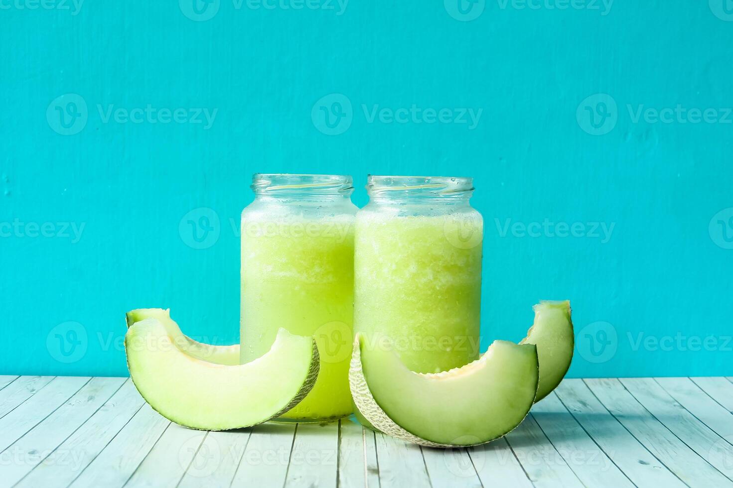 Fresh melon juice in a glass decorated with fresh melon slices on the side photo