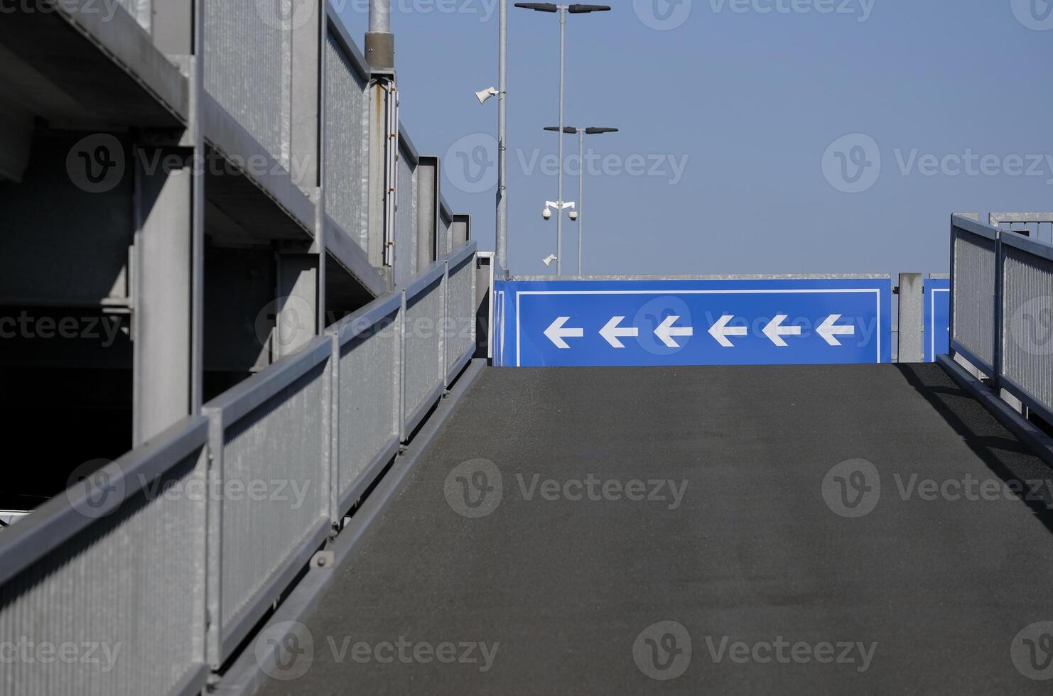 Arrows pointing to the left in the upper deck of a parking garage photo