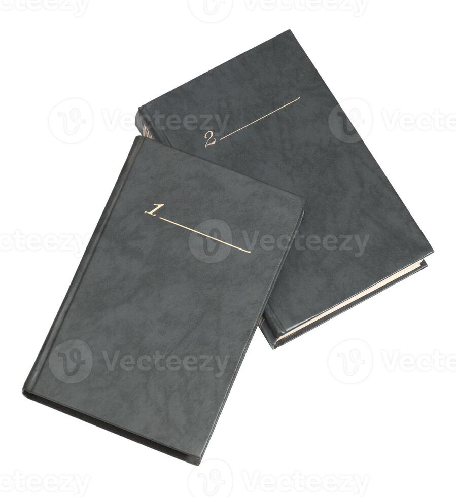 Two black notebooks with gold lettering on the front photo