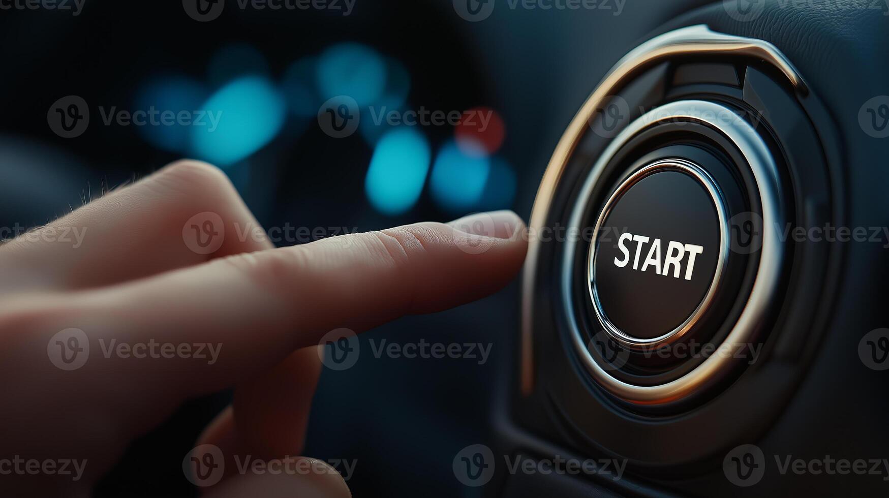 A person is pressing the start button on a car photo