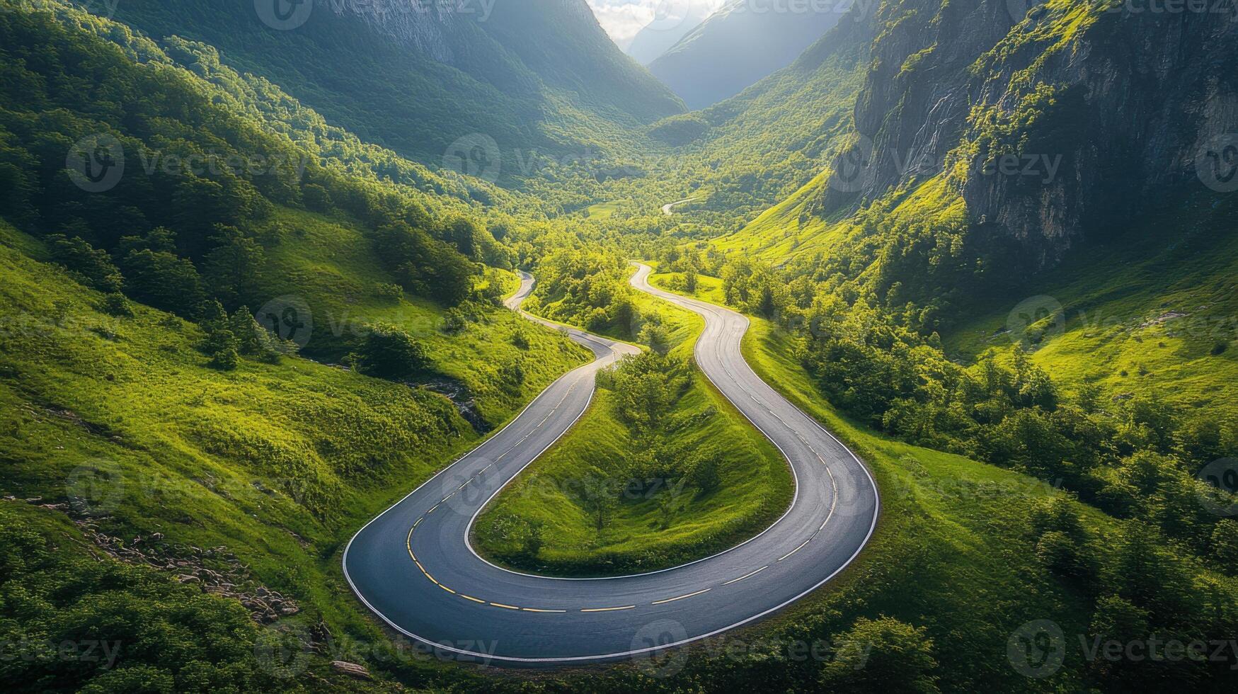 Mountain Road Curving. Green Hills Landscape. Scenic Valley Nature. Sunny Day Drive. Winding Asphalt Route. Mountainous Region Travel. Adventure Journey Outdoors. photo
