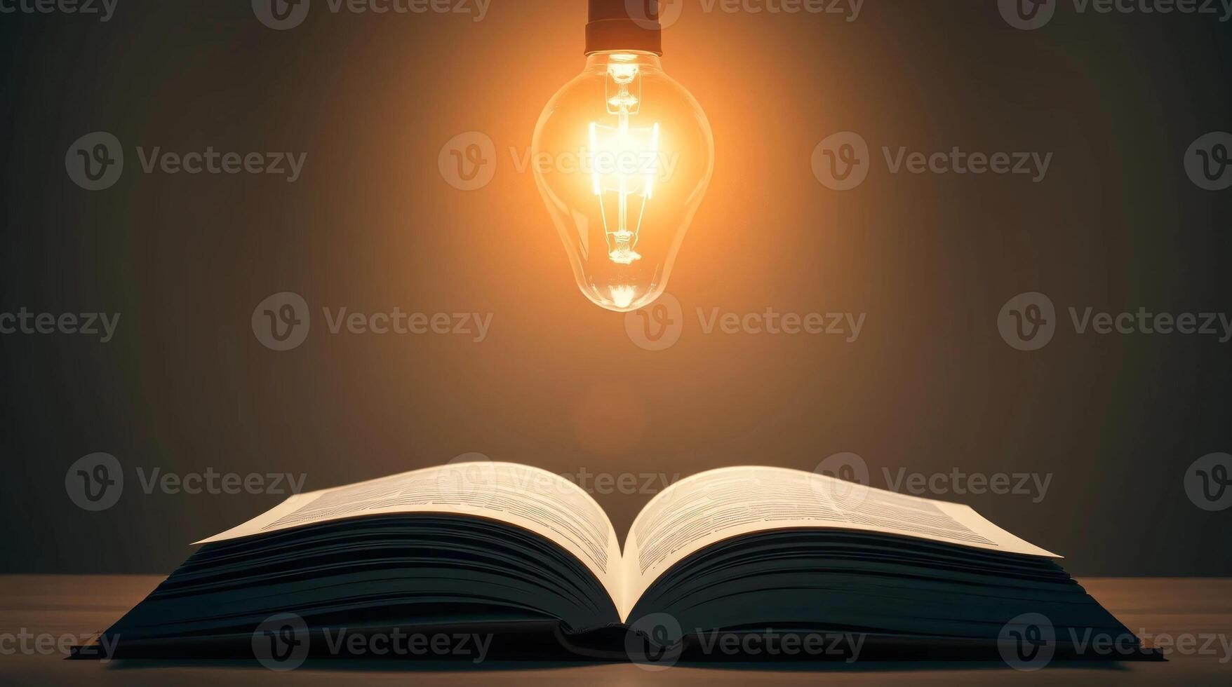 An open book with a light bulb over it photo