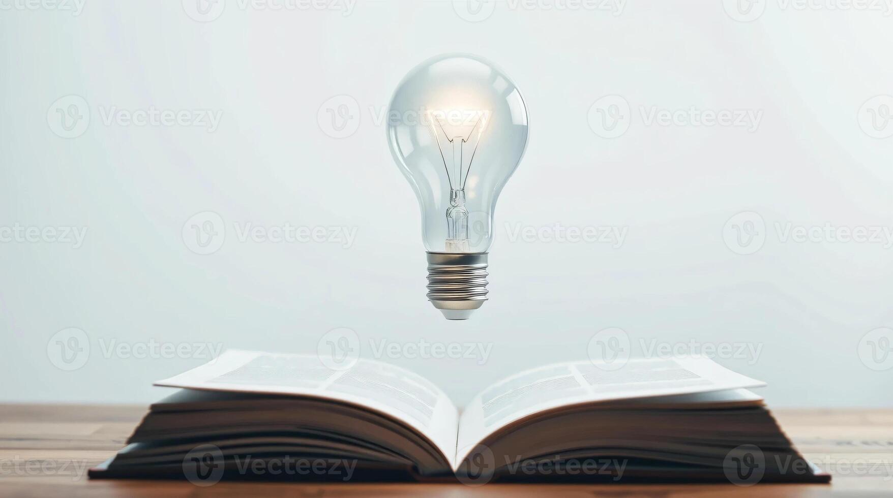 An open book with a light bulb floating above it photo