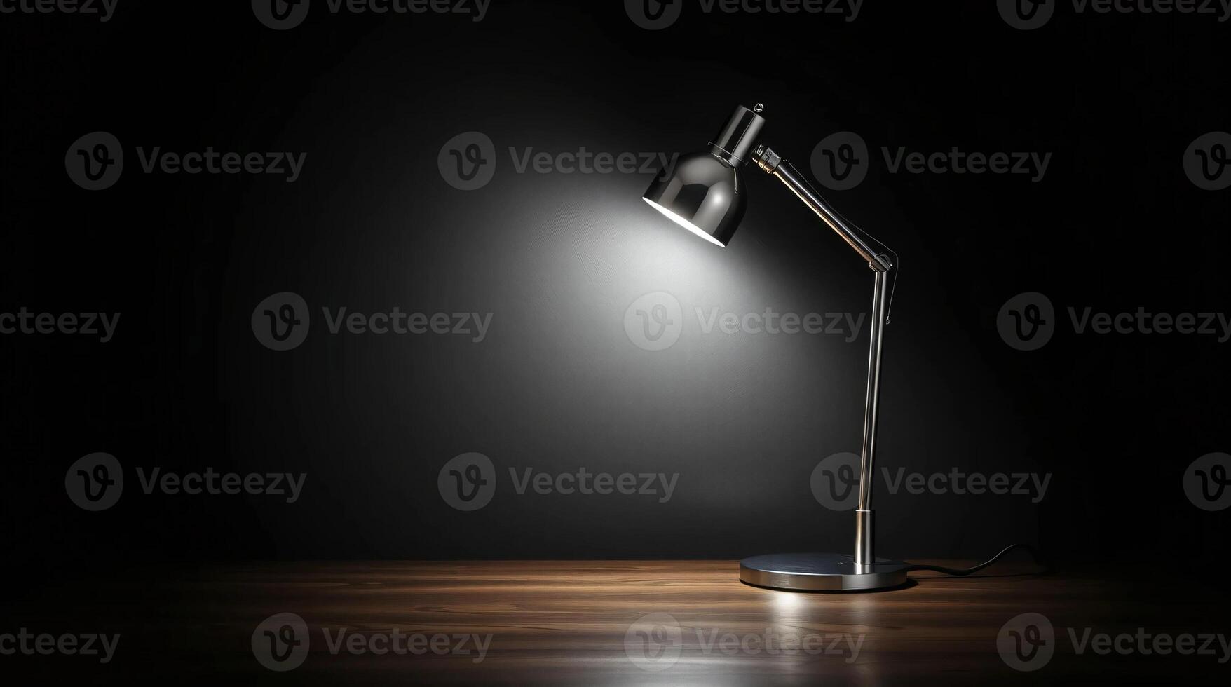 A desk lamp is on a dark table photo