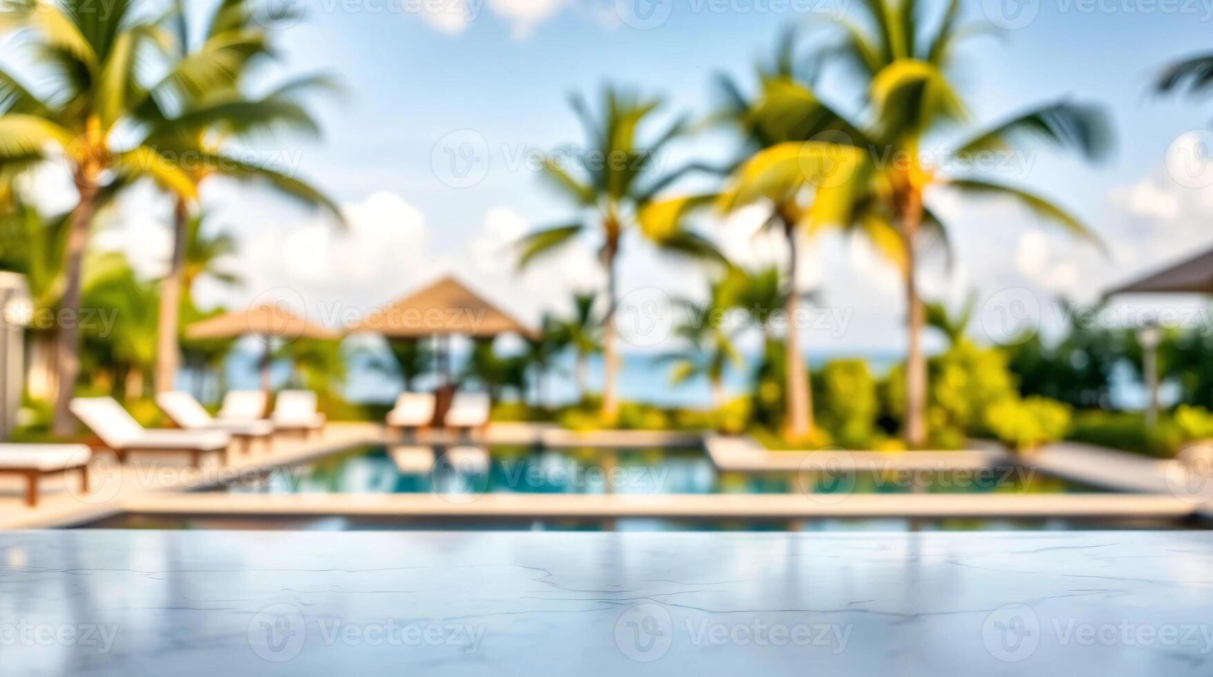 A pool with lounge chairs and palm trees in the background photo