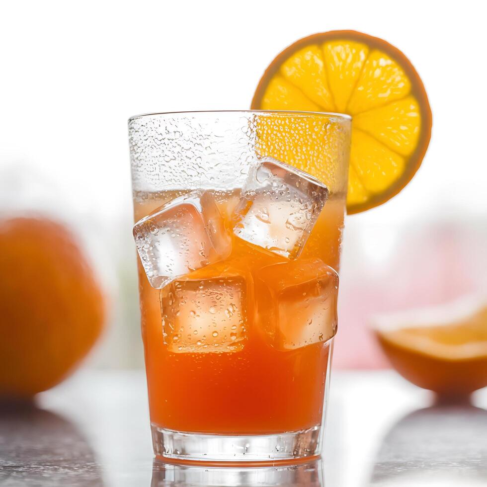 A glass of orange juice with ice cubes photo