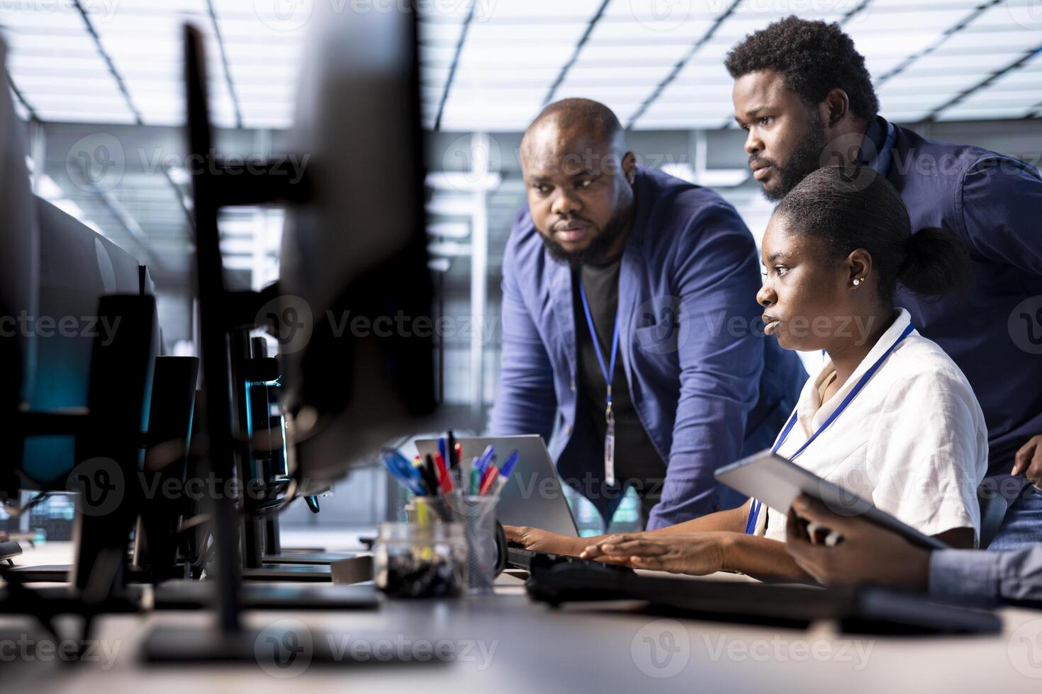 Team of data center office technicians using programming languages to construct algorithms and build applications. Server hub IT staff members debugging and optimizing code photo