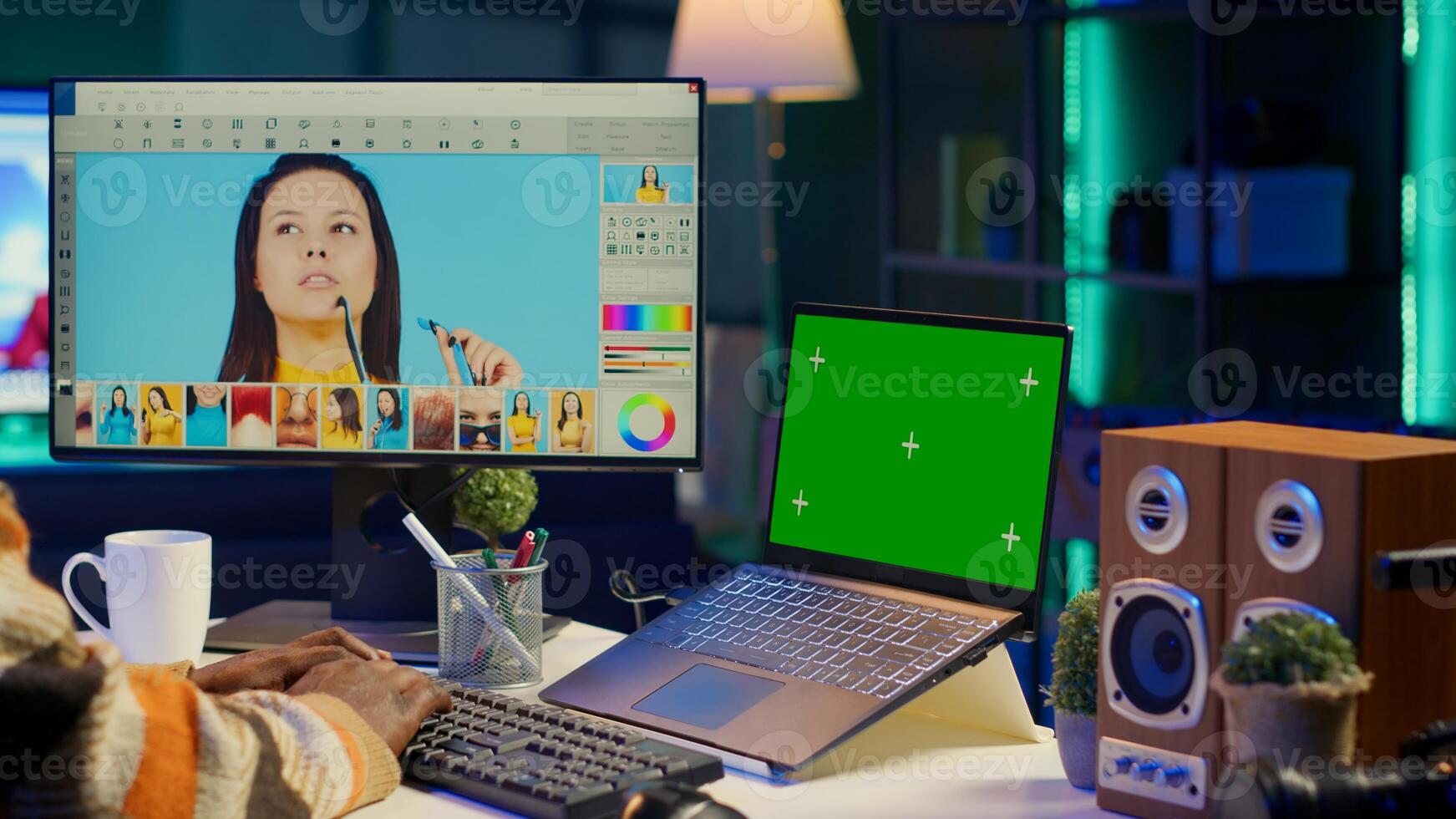 Male graphic artist using essential digital tools next to isolated mockup screen, professional design work showcasing modern setup at home. Designer showing advanced photo editing skills. Camera A.