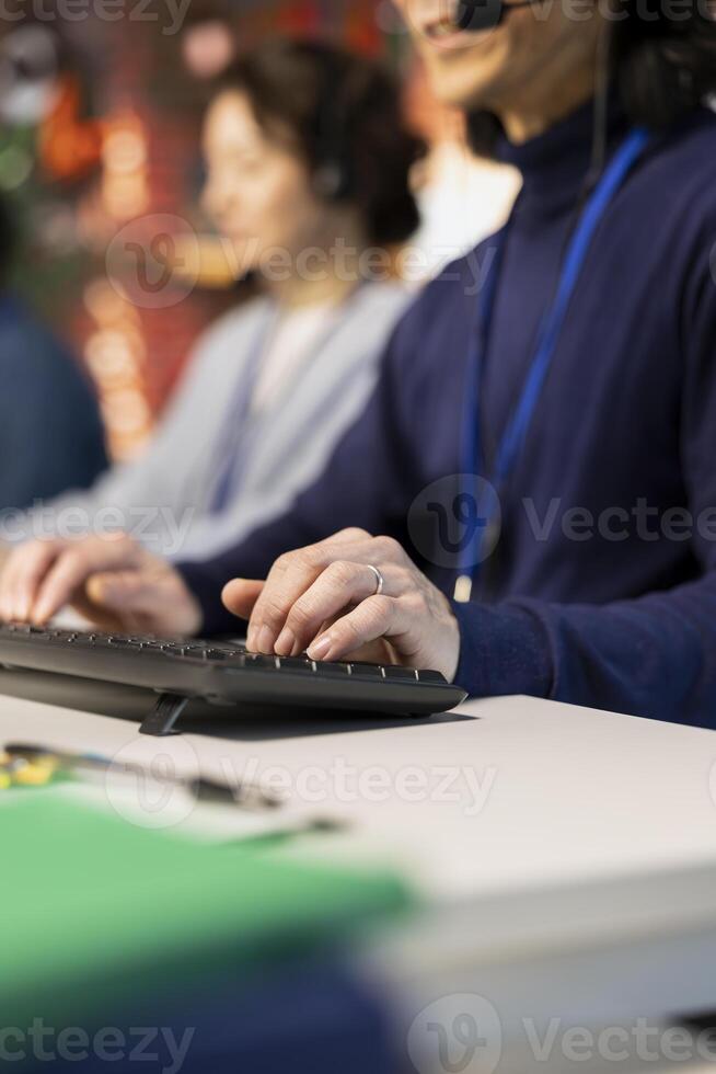 Call center staff member handling customer inquiries, complaints and support requests in office. Close up of customer service operator assisting customers with issues related to products or services photo