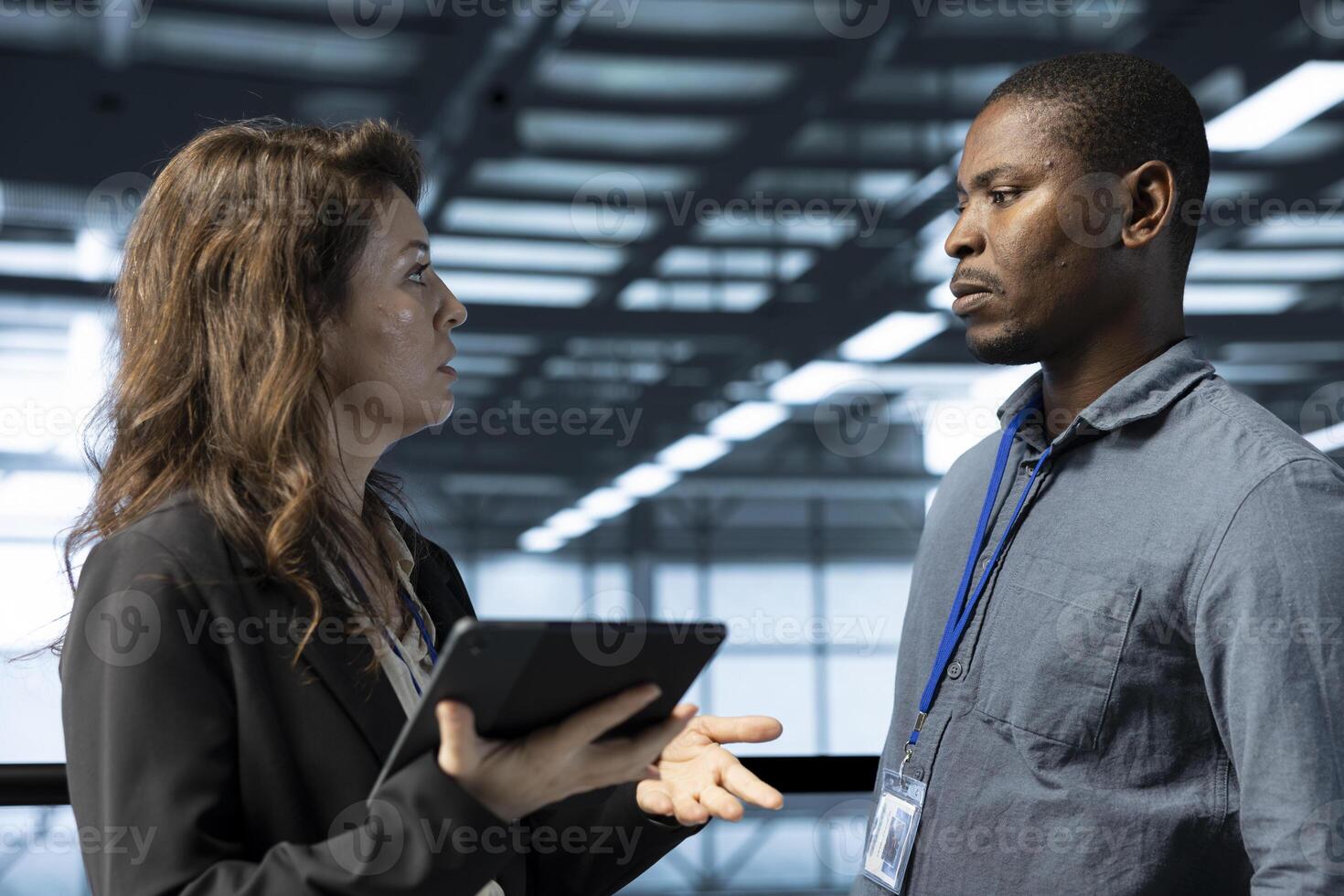 IT staff members in data center using tablet to develop disaster recovery plans. Coworkers in server hub doing brainstorming, testing failover scenarios, protecting data during disruptions photo