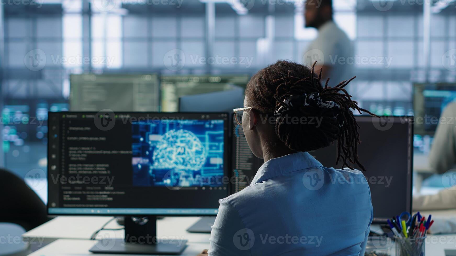Engineer typing on computer in server hub, monitoring data center energy consumption using AI software. Technician inspecting rackmounts in server room using artificial intelligence tech, camera A photo