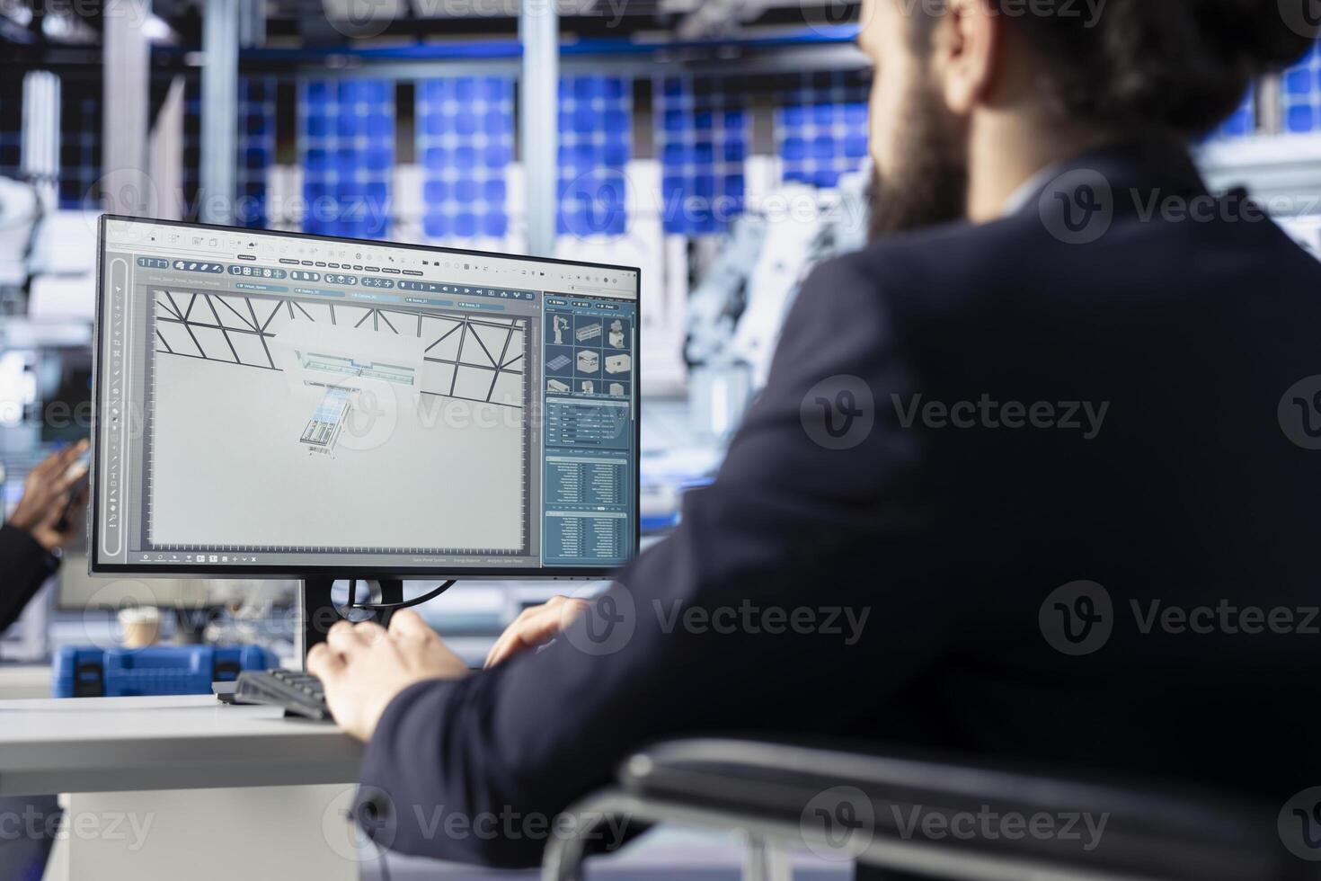 Photovoltaics factory manager in office visualizing solar cells designs with 3D software on PC. Solar panels plant technician sitting down at desk doing computer simulations in CAD program photo