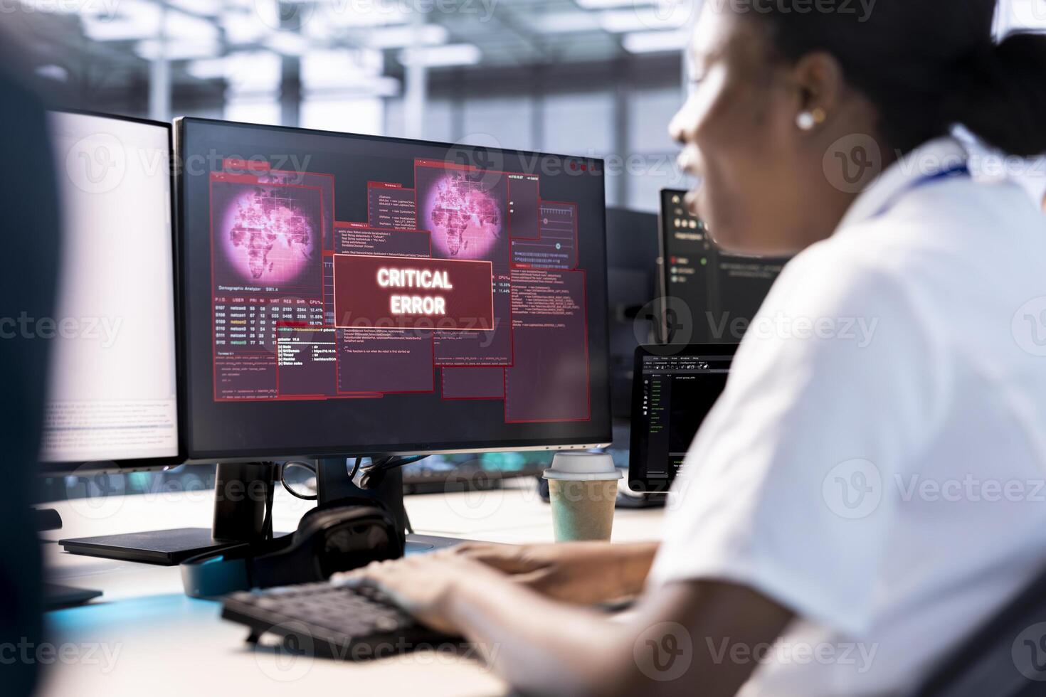 African american computer scientist in server hub working to protect equipment from hacker. Woman in data center establishment in need of help from engineers to fix security breach alert photo