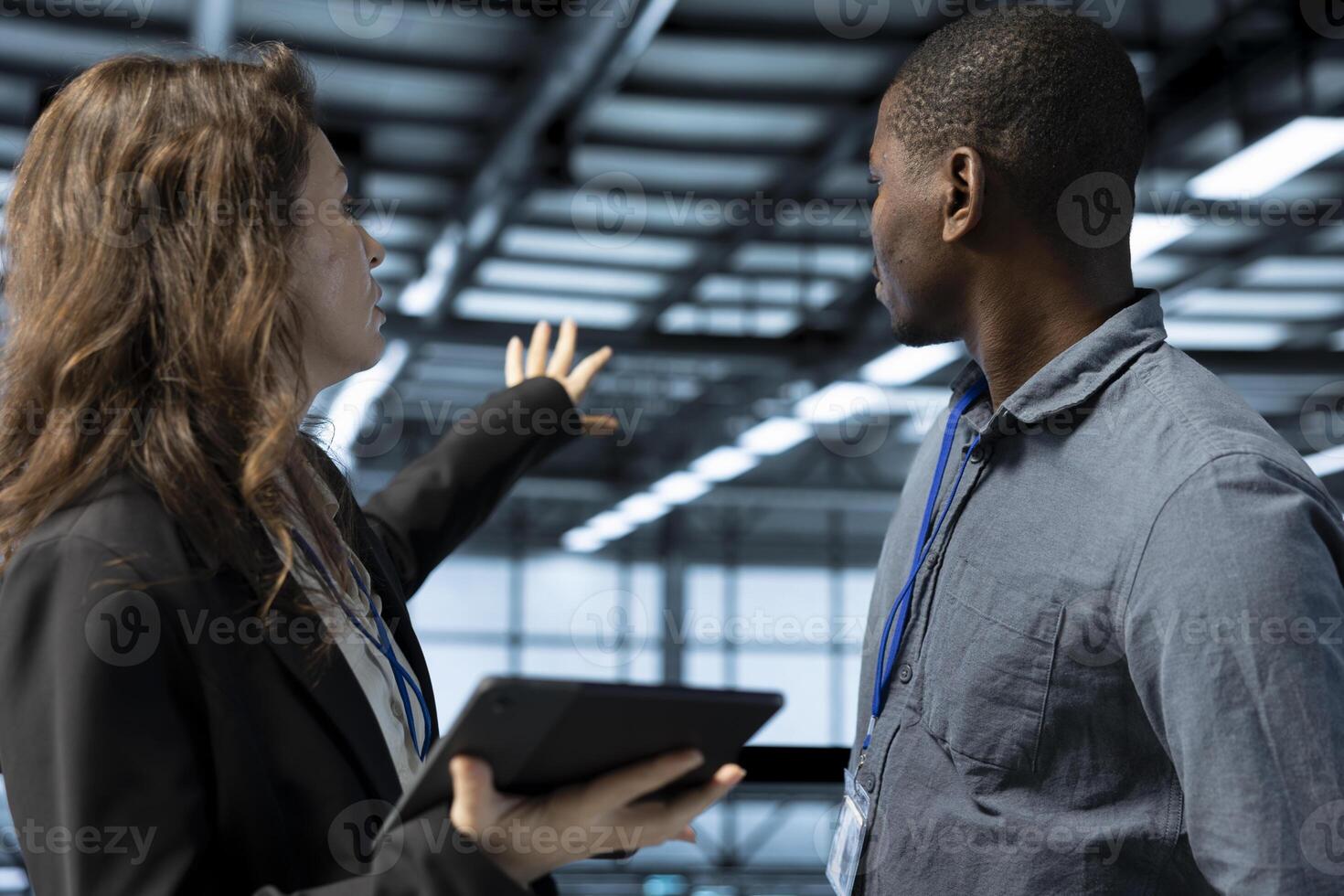 Data center computer scientists using laptop, conducting security audits, preventing errors. Close up of colleagues cooperating to review firewall rules, logging incident details, talking photo