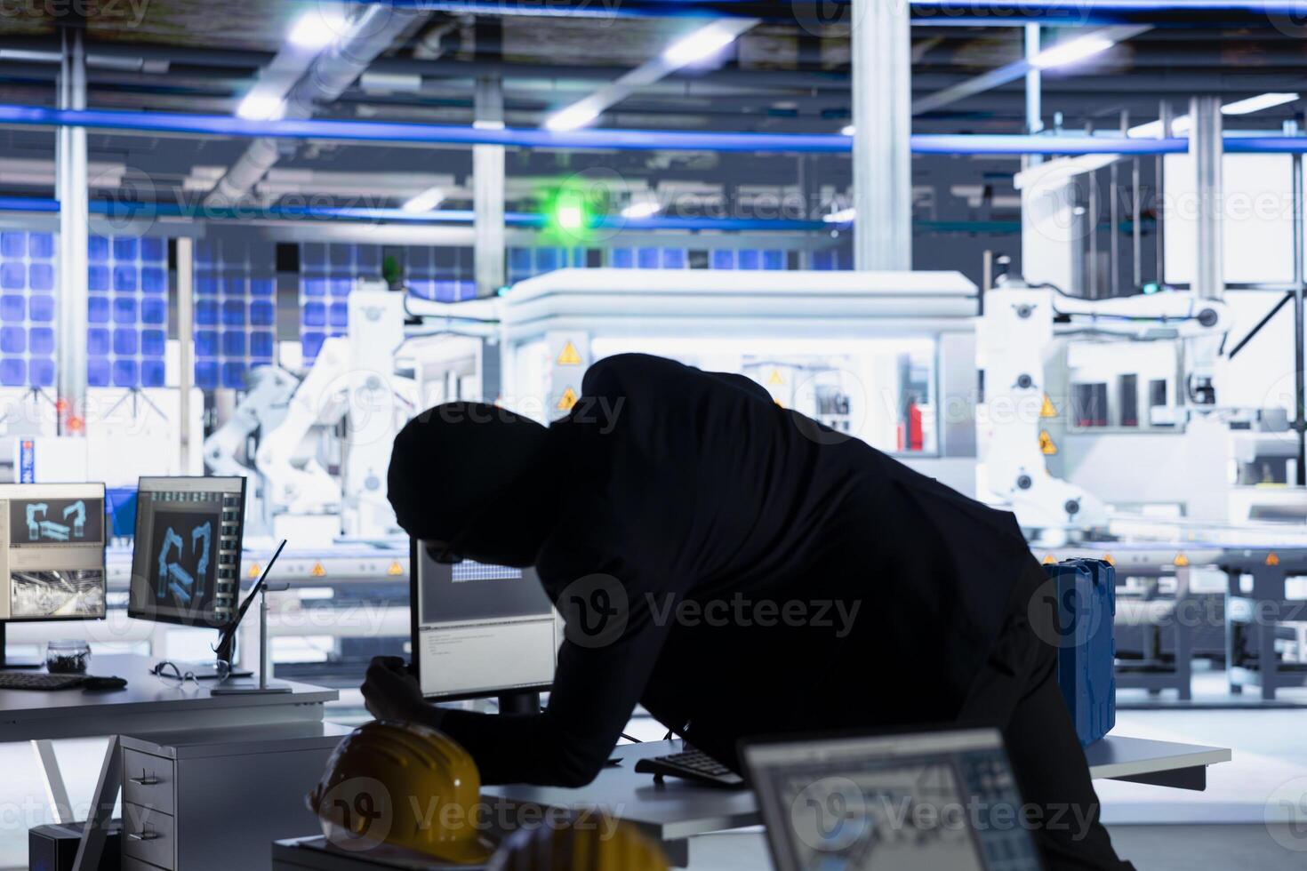 Masked hacker sneaking into solar panel plant at night, inserting USB stick into PC to steal confidential manufacturing data. Thief in photovoltaics facility extracts company files and uploading malware photo