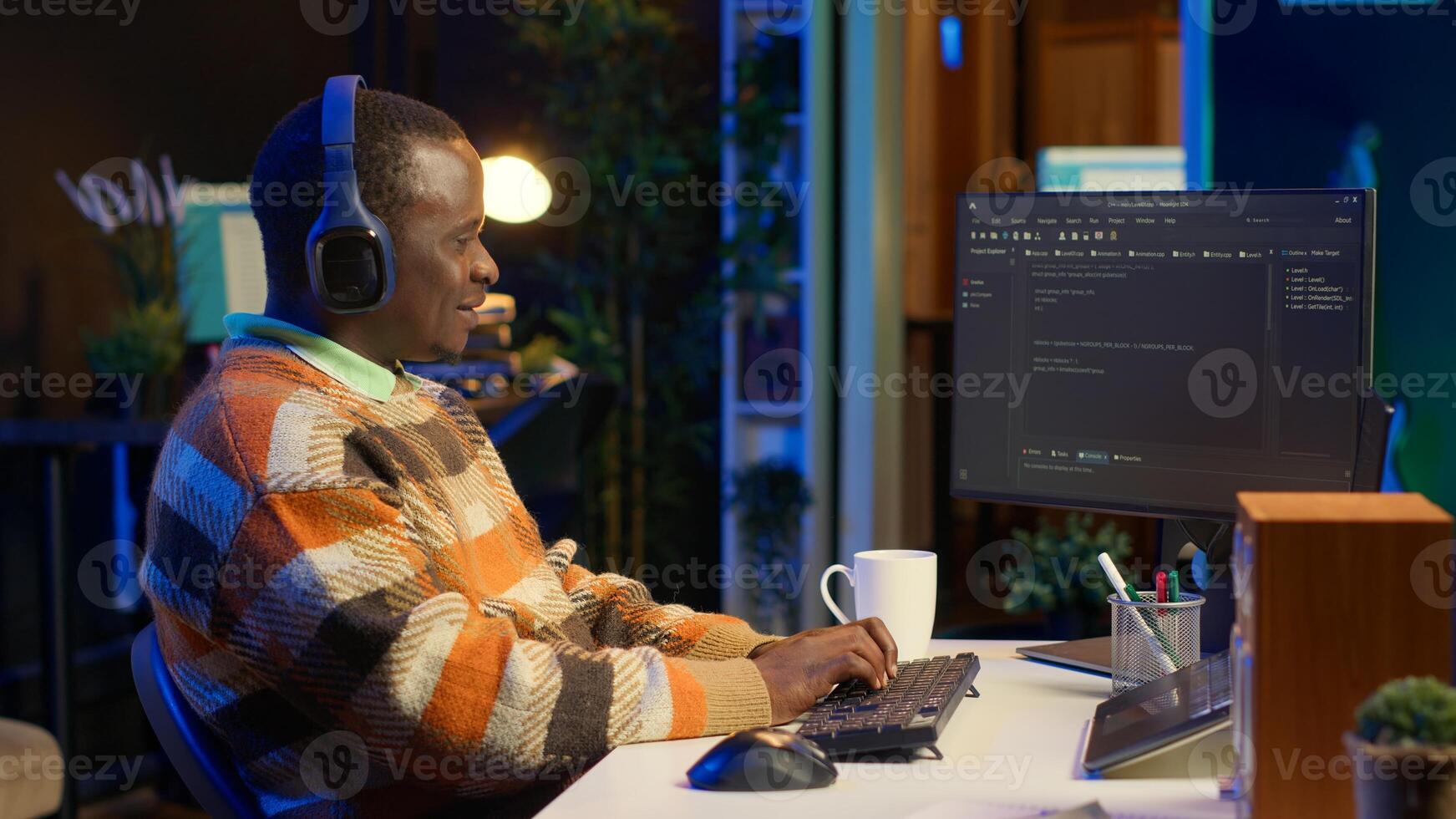 African american computer scientist in home office programming code on pc. Freelancing developer solving tasks for an IT job, writing lines of code at his personal office, cybersecurity. Camera A. photo