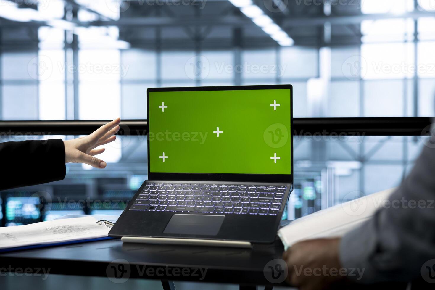 Teamworking technicians in data center use mockup notebook, observing analytics, reviewing equipment health. Server room IT experts using isolated screen laptop, adjusting system parameters, close up photo