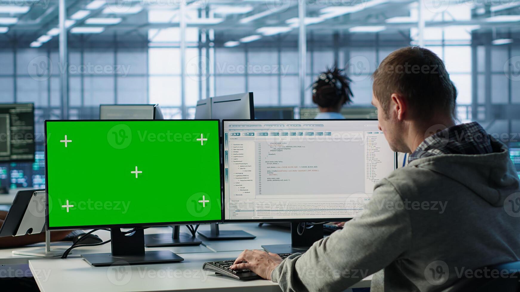 Software developer using green screen PC to do programming in server room providing computing resources for workloads. IT expert supervising data center supercomputers using mockup computer, camera A photo