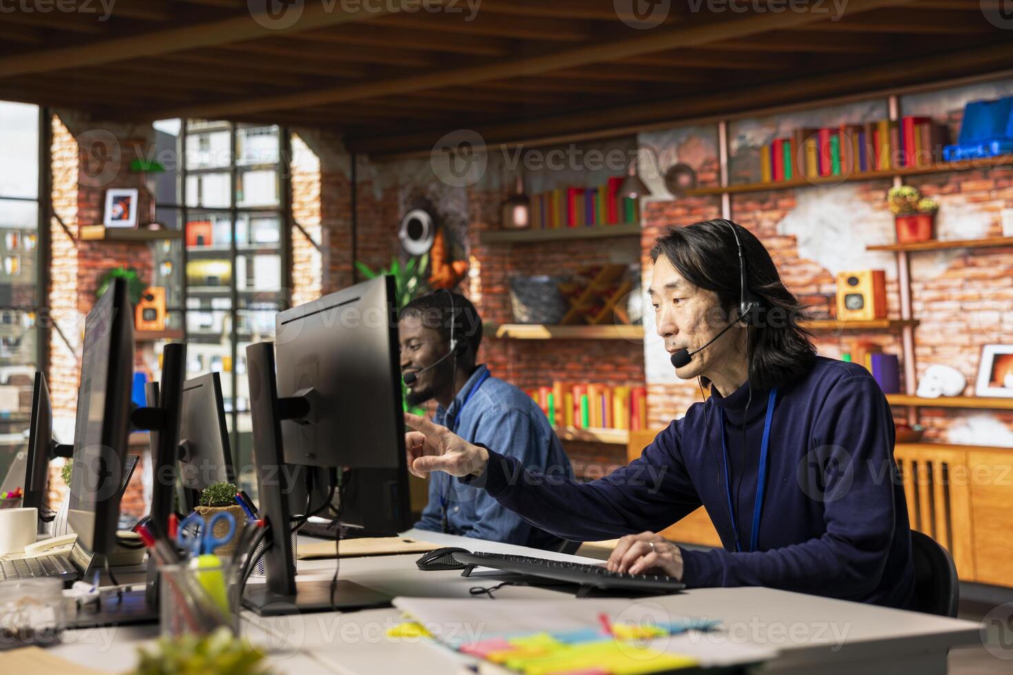 Team of call center agents at office desk handling customer inquiries, complaints and support requests. Customer service coworkers assisting clients with issues related to products photo