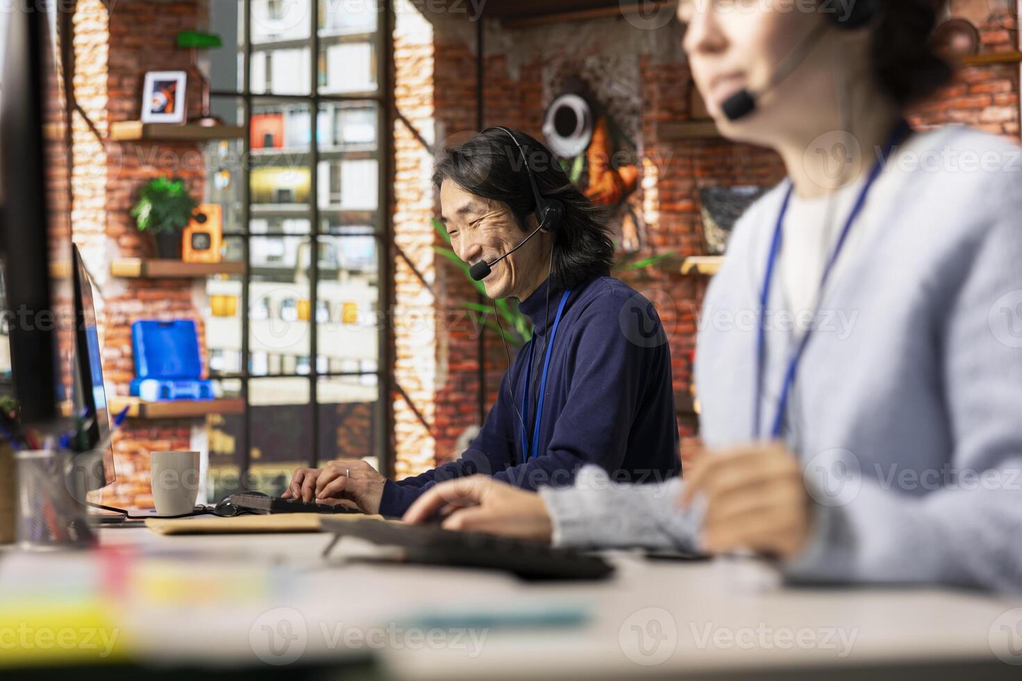 Jolly call center senior agent analyzes customer feedback, working to reduce issues. Joyous Asian customer service employee using problem solving skills to address customer needs photo