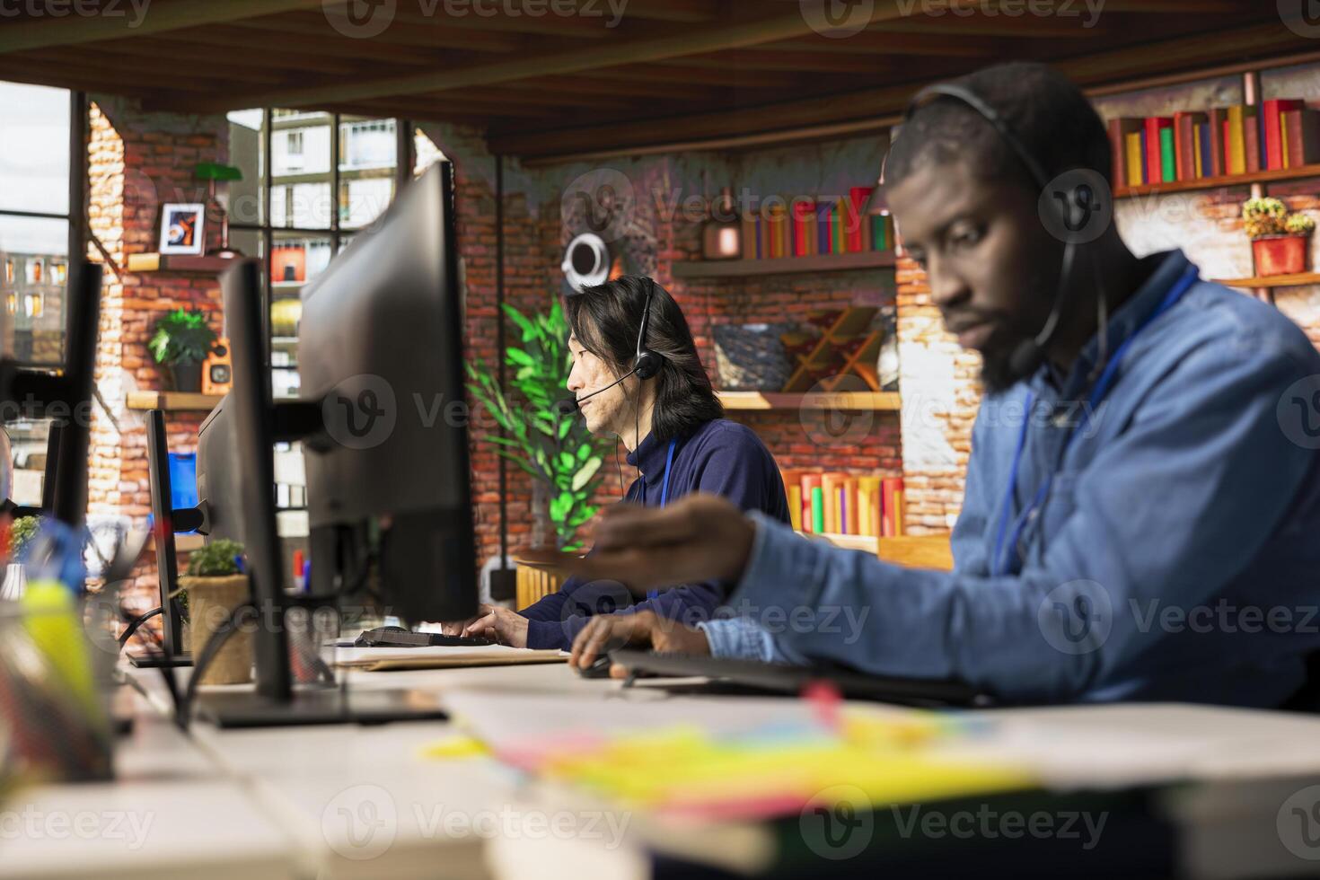 Call center coworkers in workplace helping customers regain access to accounts and devices. Teamworking customer support colleagues assisting clients needing help resetting password photo