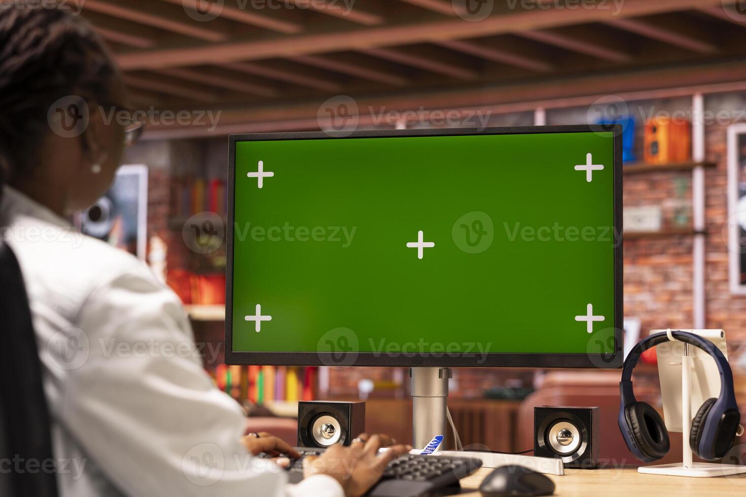 Remote worker typing on green screen PC keyboard, doing tasks for team project in home office. Teleworker using mockup PC, doing research for company project, typing on keyboard photo
