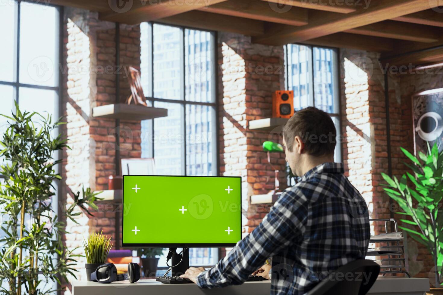 Person in home office analyzing data charts on mockup computer, interpreting statistical graphs, identifying trends. Freelancer using green screen PC, compiling analytical reports, processing data photo