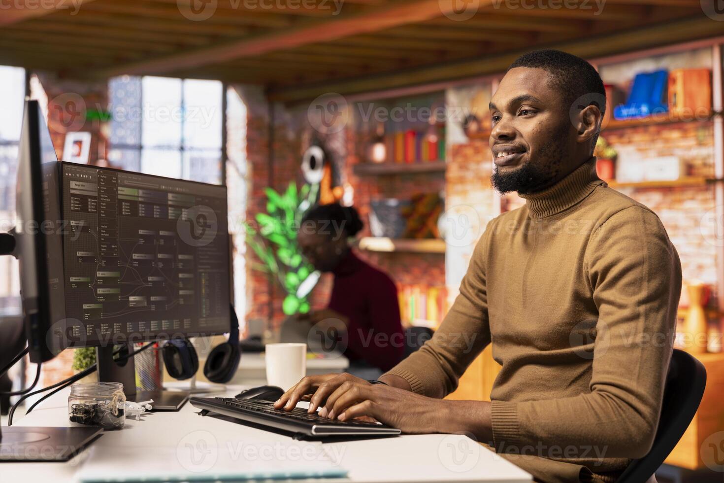 Happy man working in AI tech agency providing custom software development services. Cheerful african american IT expert using machine learning to streamline coding process in startup office photo