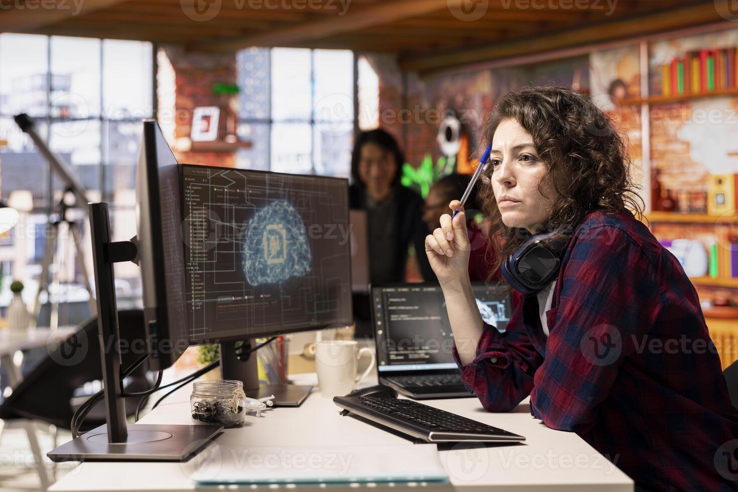 Woman working in AI tech agency providing custom software development services. IT expert using artificial intelligence technology to streamline coding process in innovative startup office photo