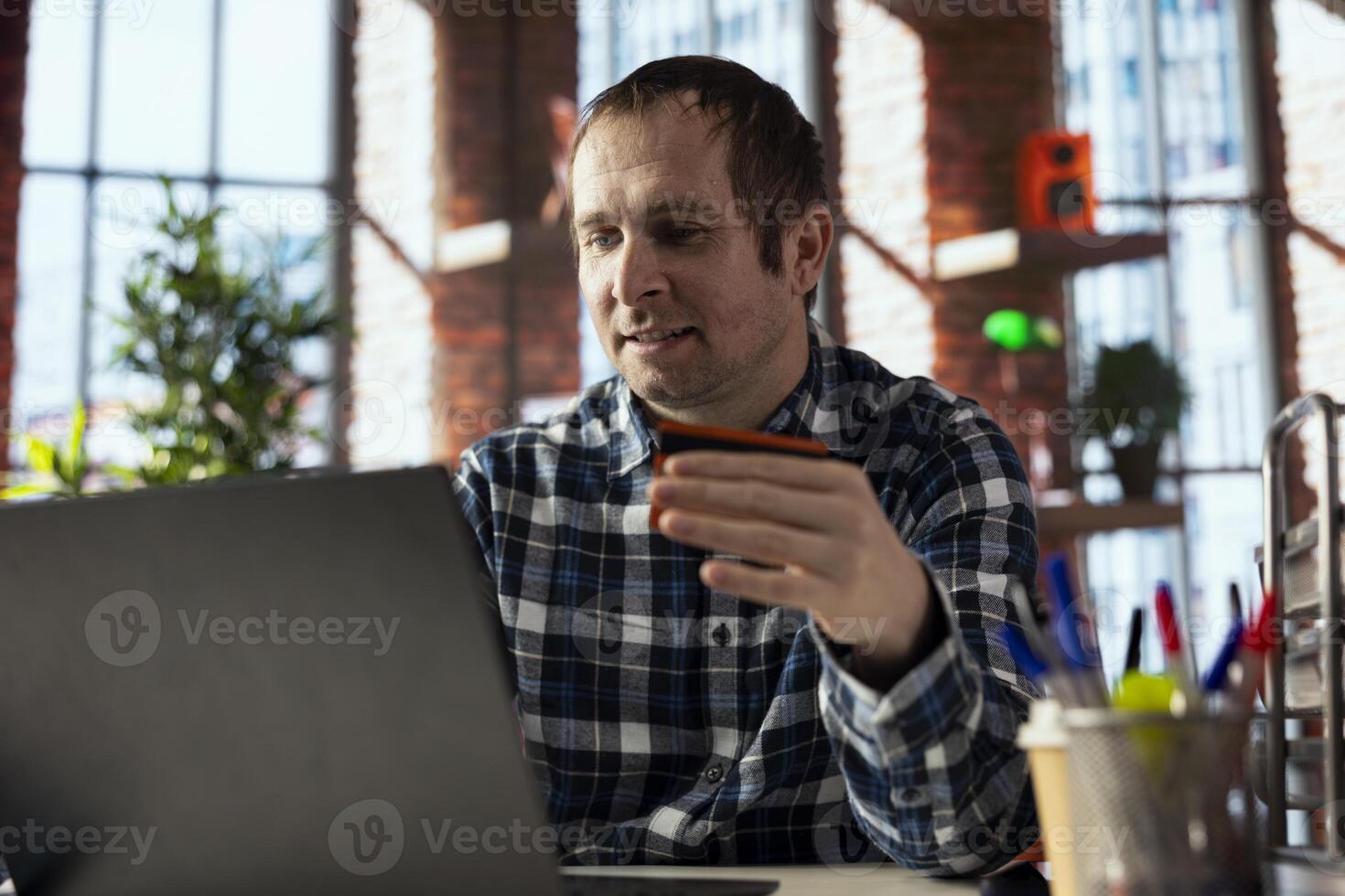 Man doing online payments with credit card, loading cart with items, doing checkout process. Person using internet marketplace to make purchases, typing credit card details to finish transaction photo