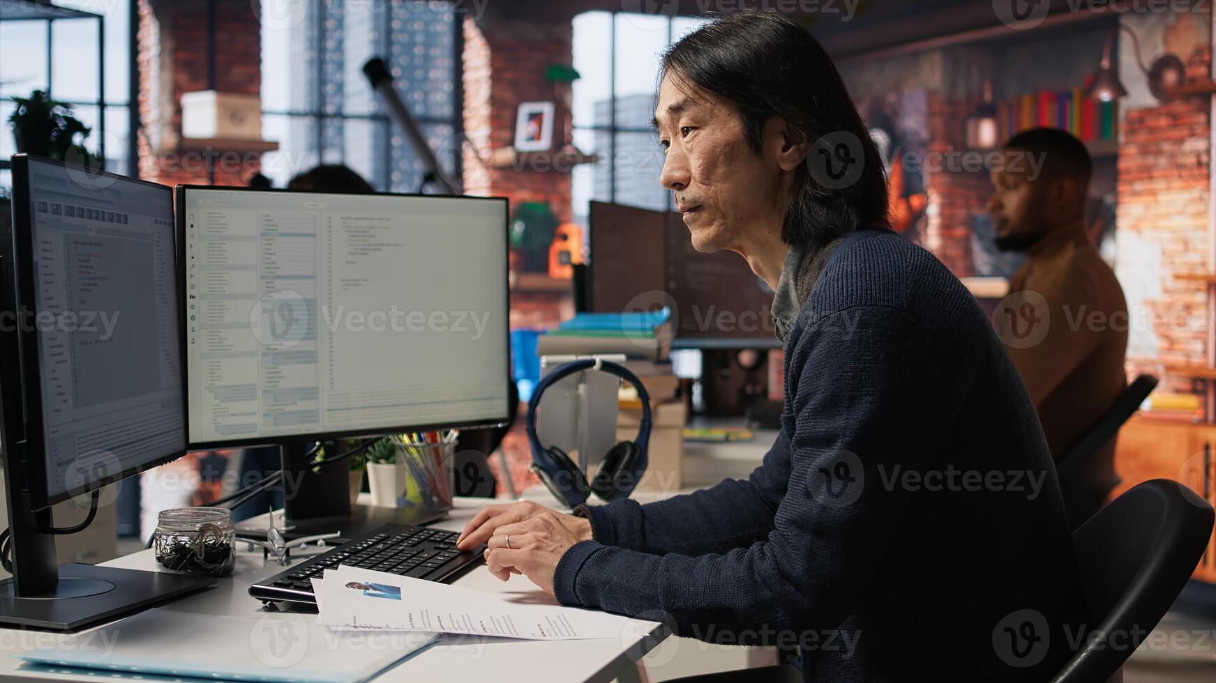 Senior tech startup HR recruiter identifying candidates for job opening, reviewing CVs to determine qualifications. Headhunter screening engineers for software development position, camera A photo