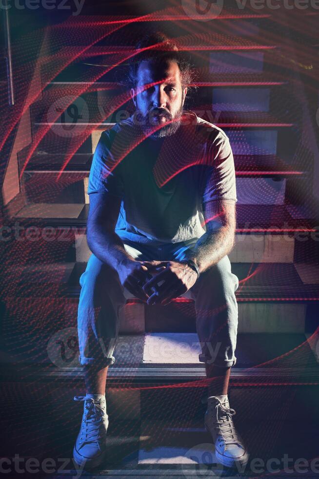 Man sitting on stairs in nightclub photo
