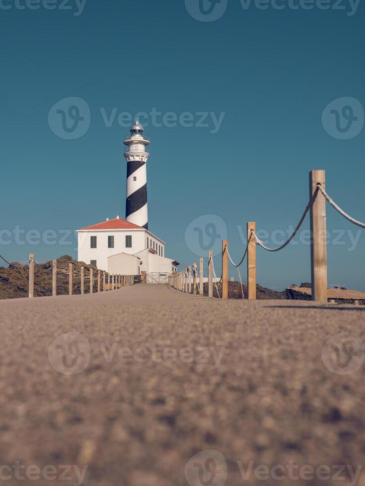 Sidewalk leading to lighthouse in countryside photo