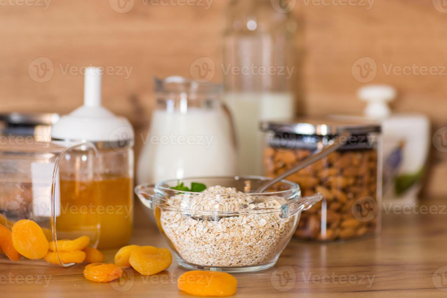 Healthy raw oatmeal in bowl on wooden table photo