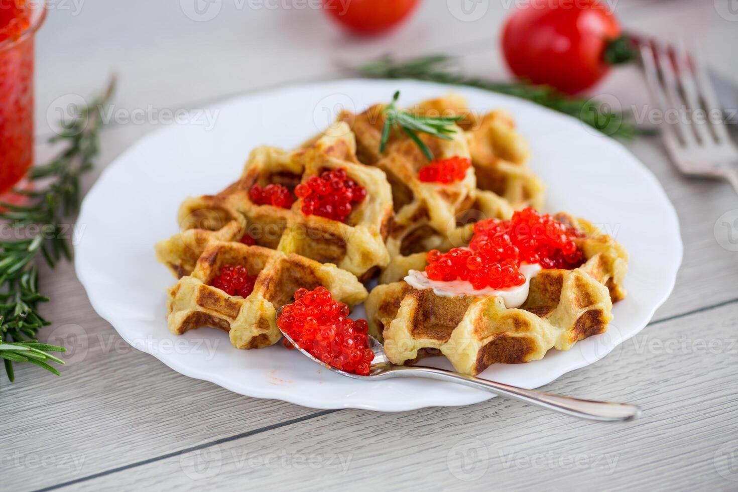 Quick and easy dinner.Potato waffles with red caviar on a wooden table photo