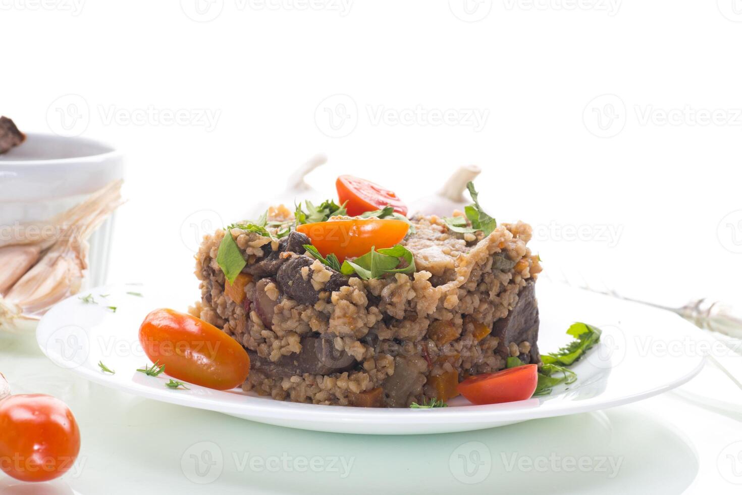 Quick and easy dinner.boiled bulgur in a plate with cherry tomatoes, isolated on white background photo