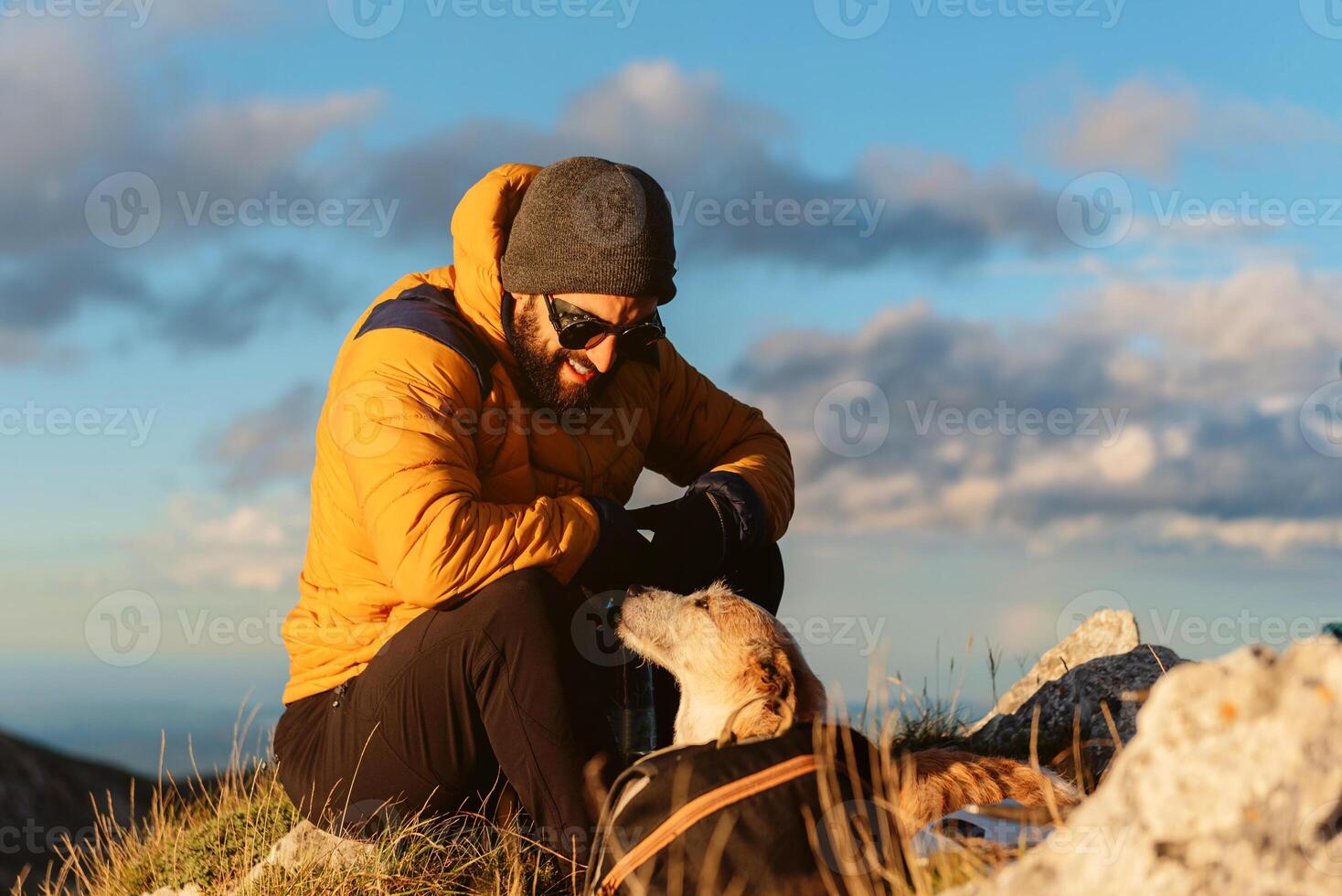 people hiking in the mountains. man and his dog photo
