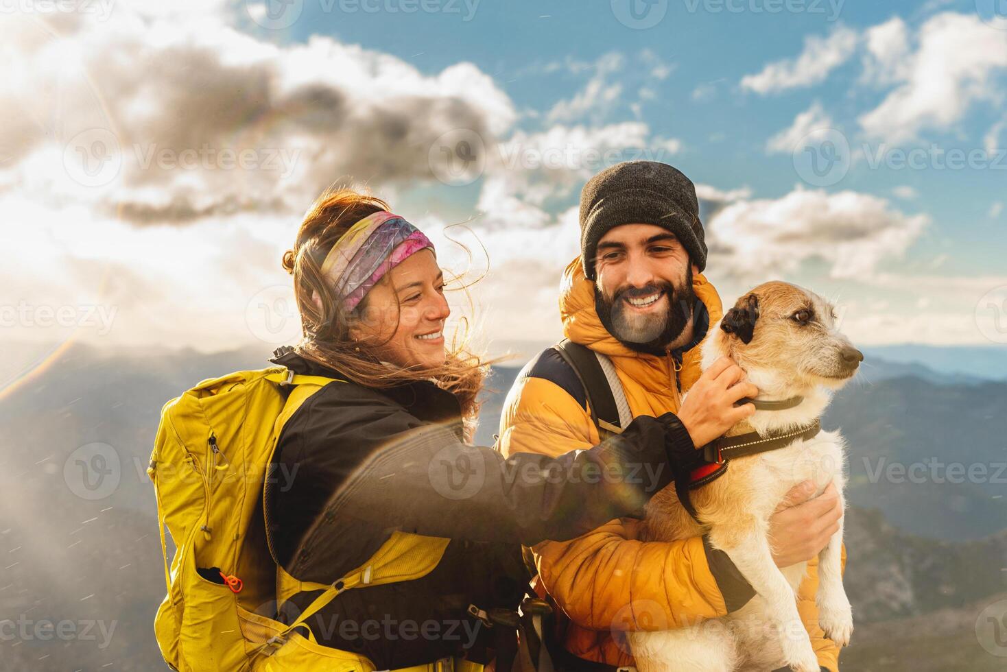 people trekking in the mountains with pet enjoying the breathtaking views photo